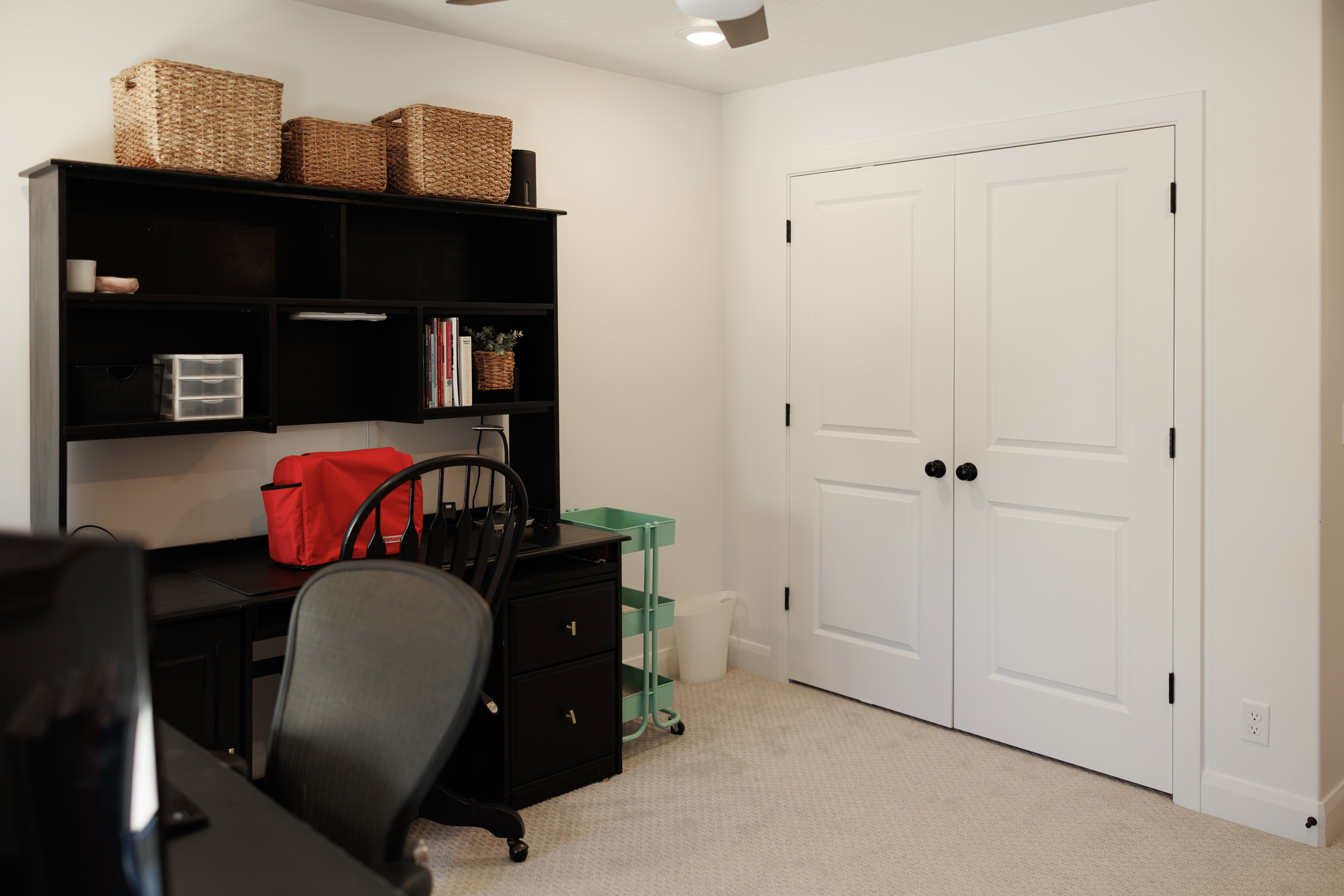 Textured neutral carpeting complements light-colored walls