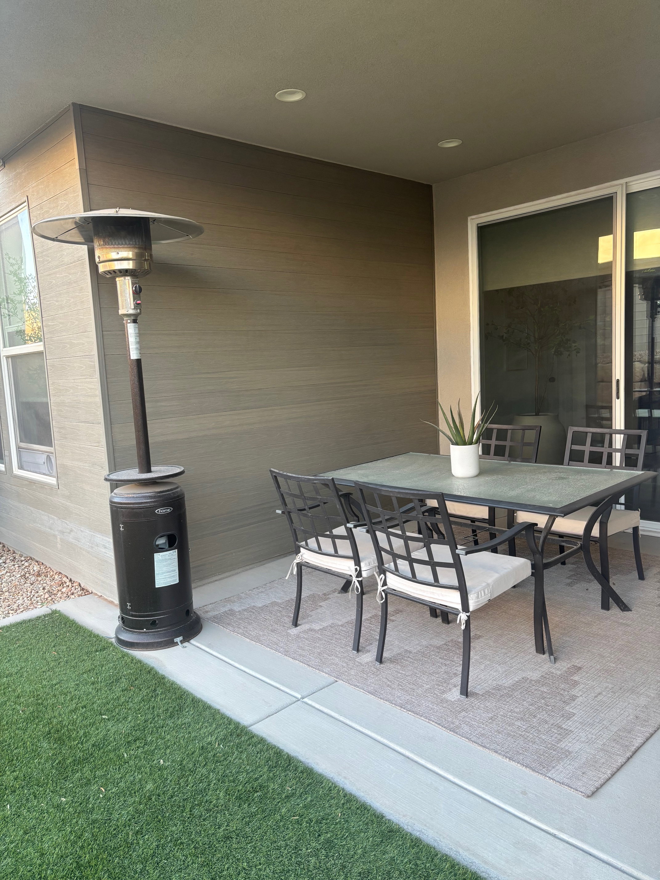Covered patio featuring recessed lighting, a sliding glass door, and exterior cladding
