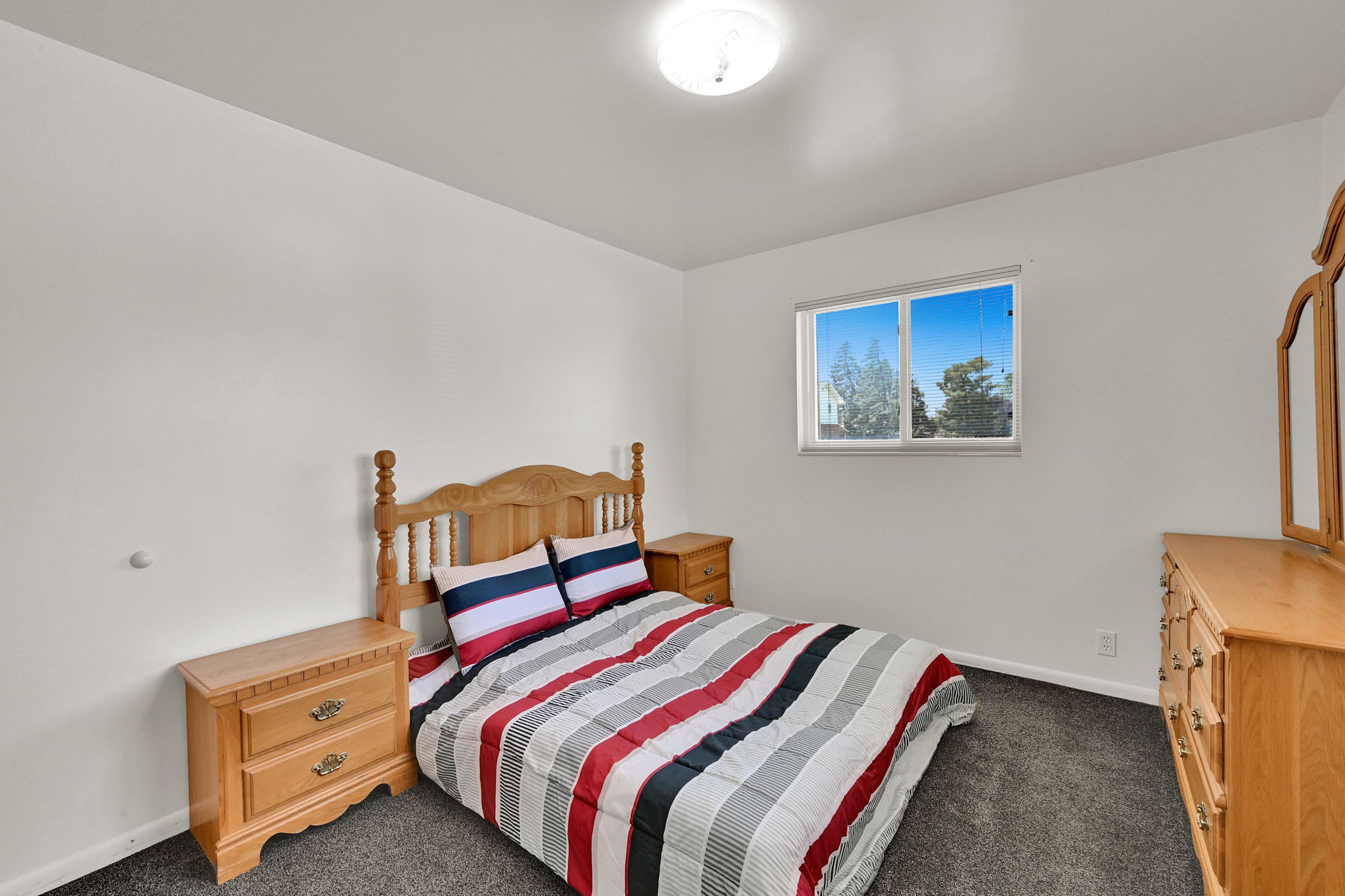 Bedroom featuring a window, neutral-toned walls, and carpet flooring