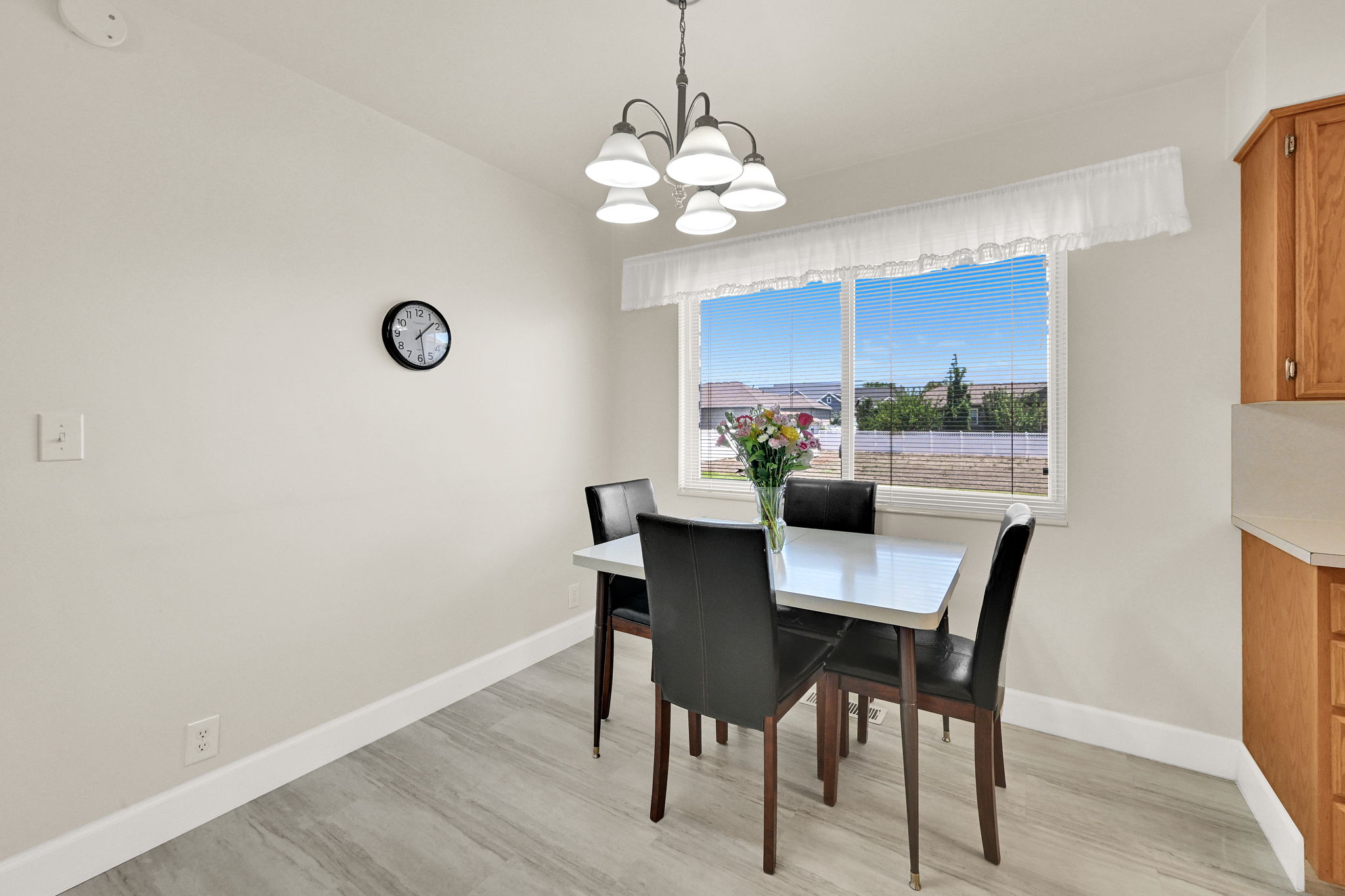Dining area with a large window and distant landscape