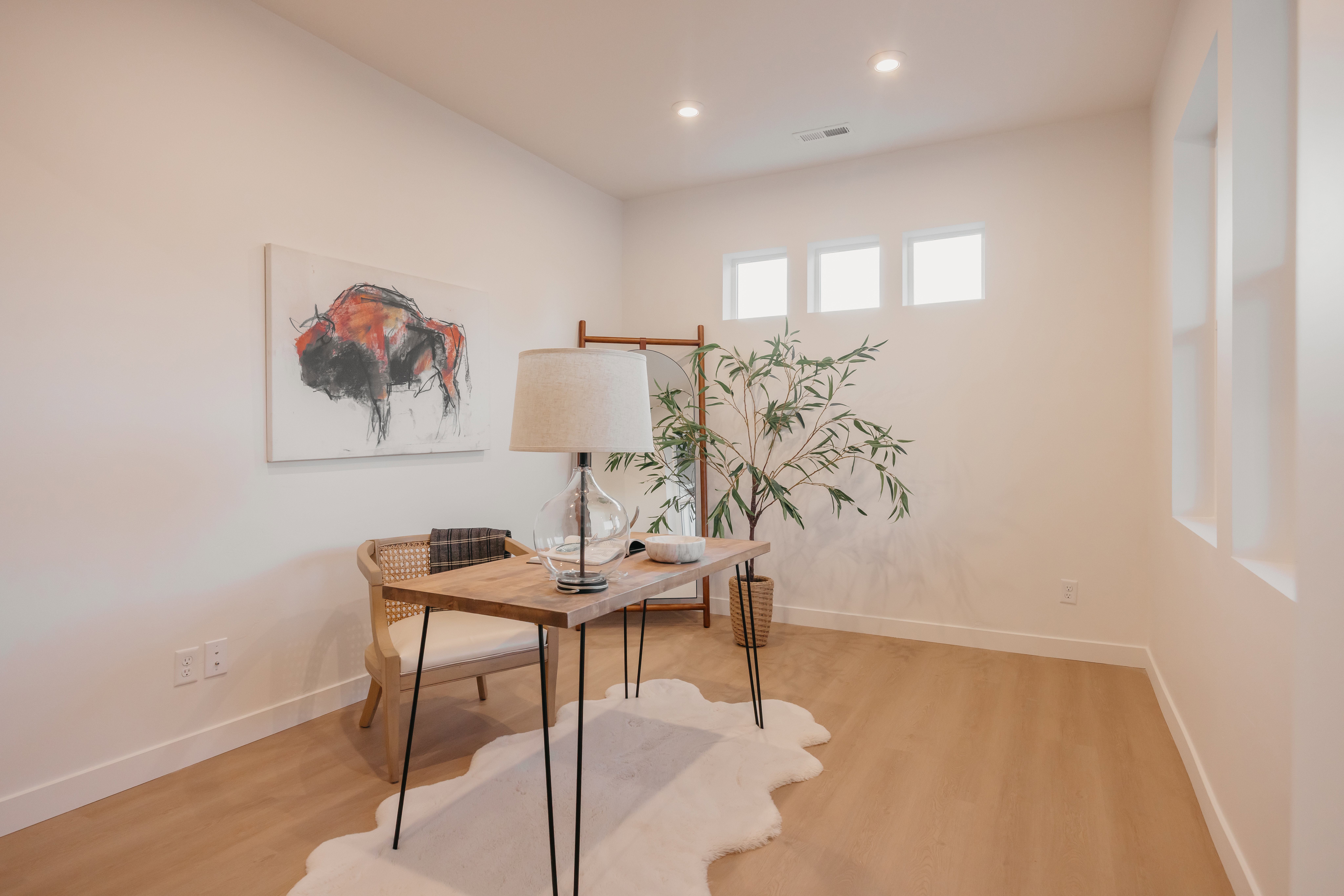 Recessed ceiling lighting illuminates light wood-finish flooring