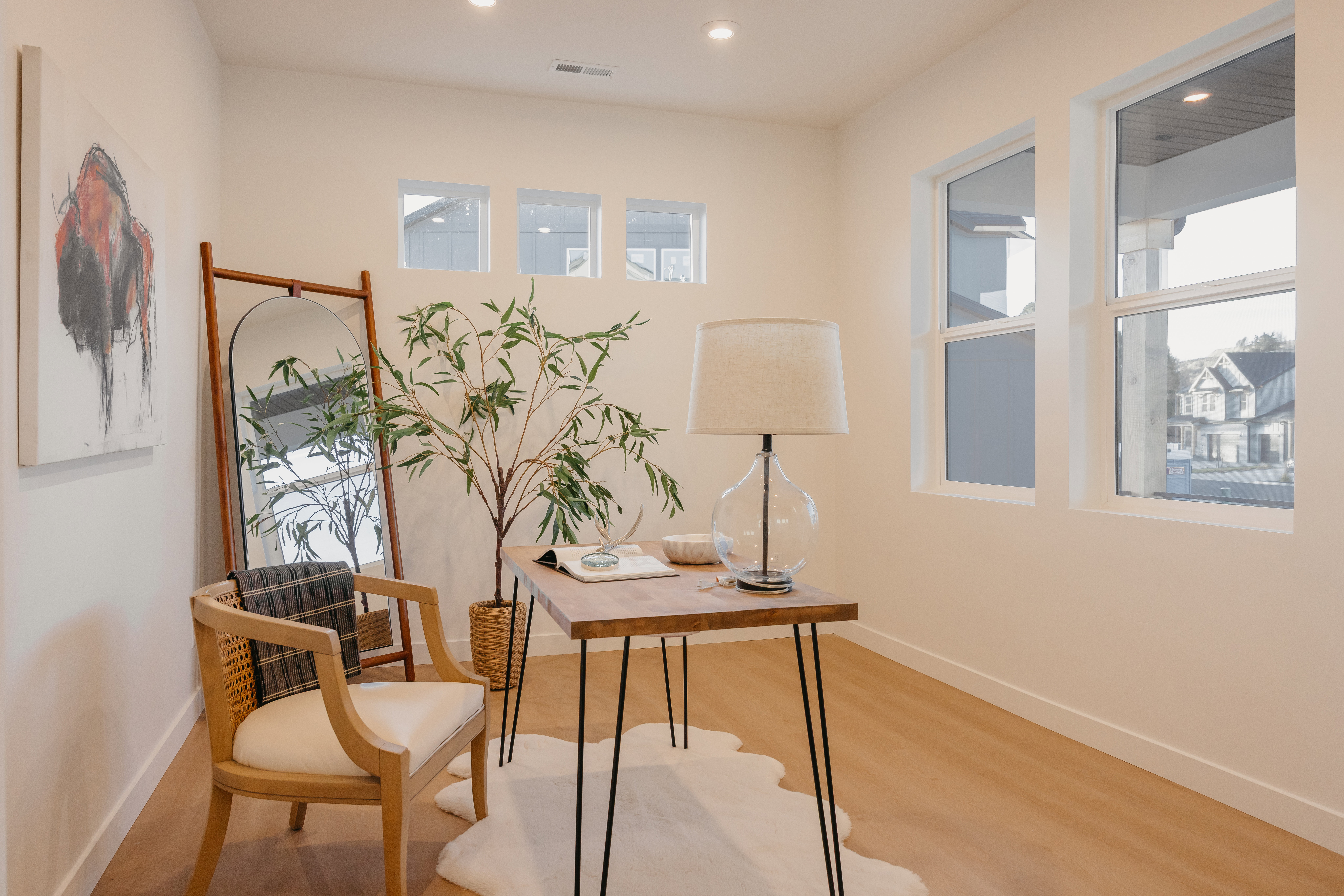 Bright room featuring light wood-finish flooring, recessed lighting, and multiple windows