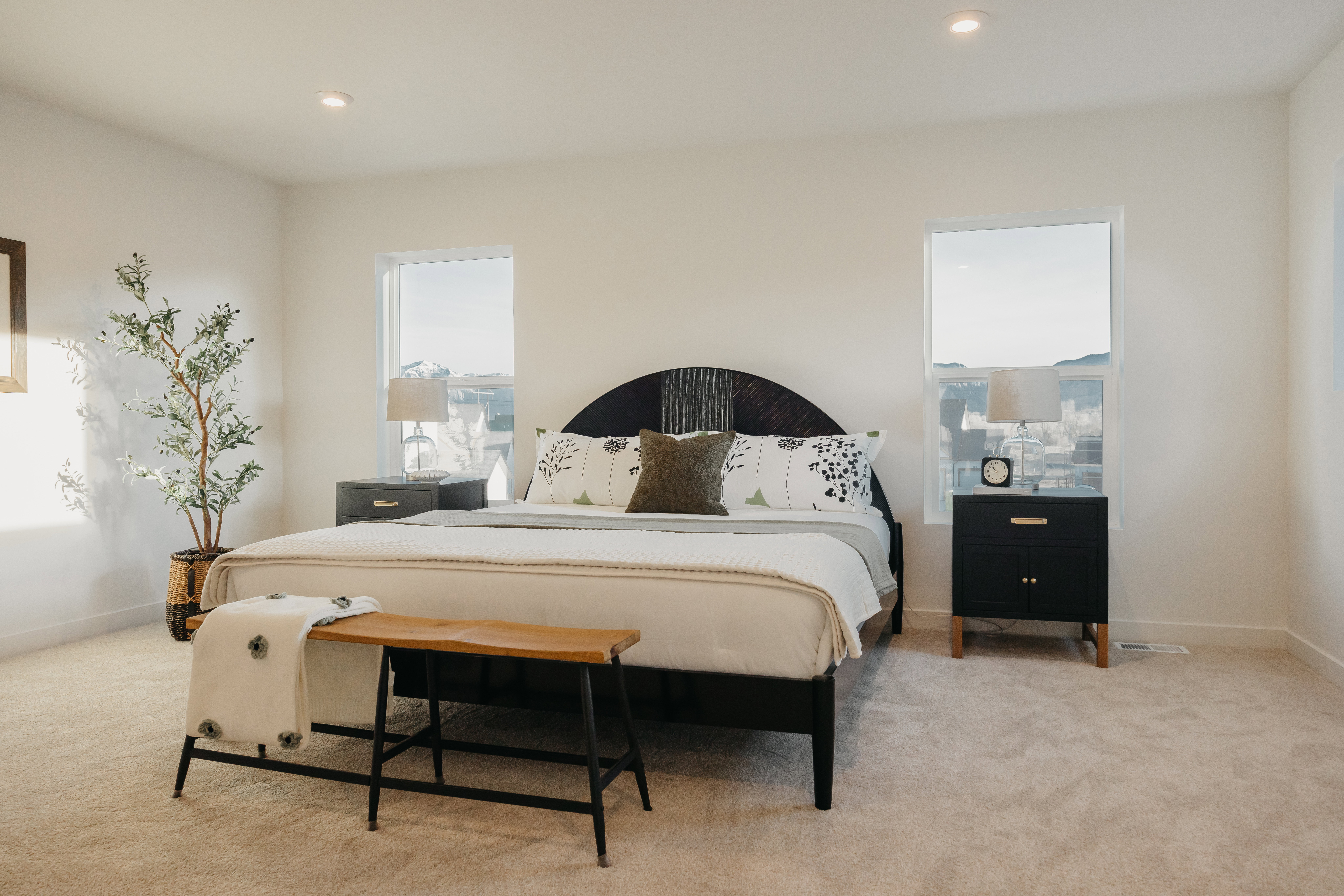 Carpeted bedroom featuring two windows, recessed lighting, and a neutral color palette
