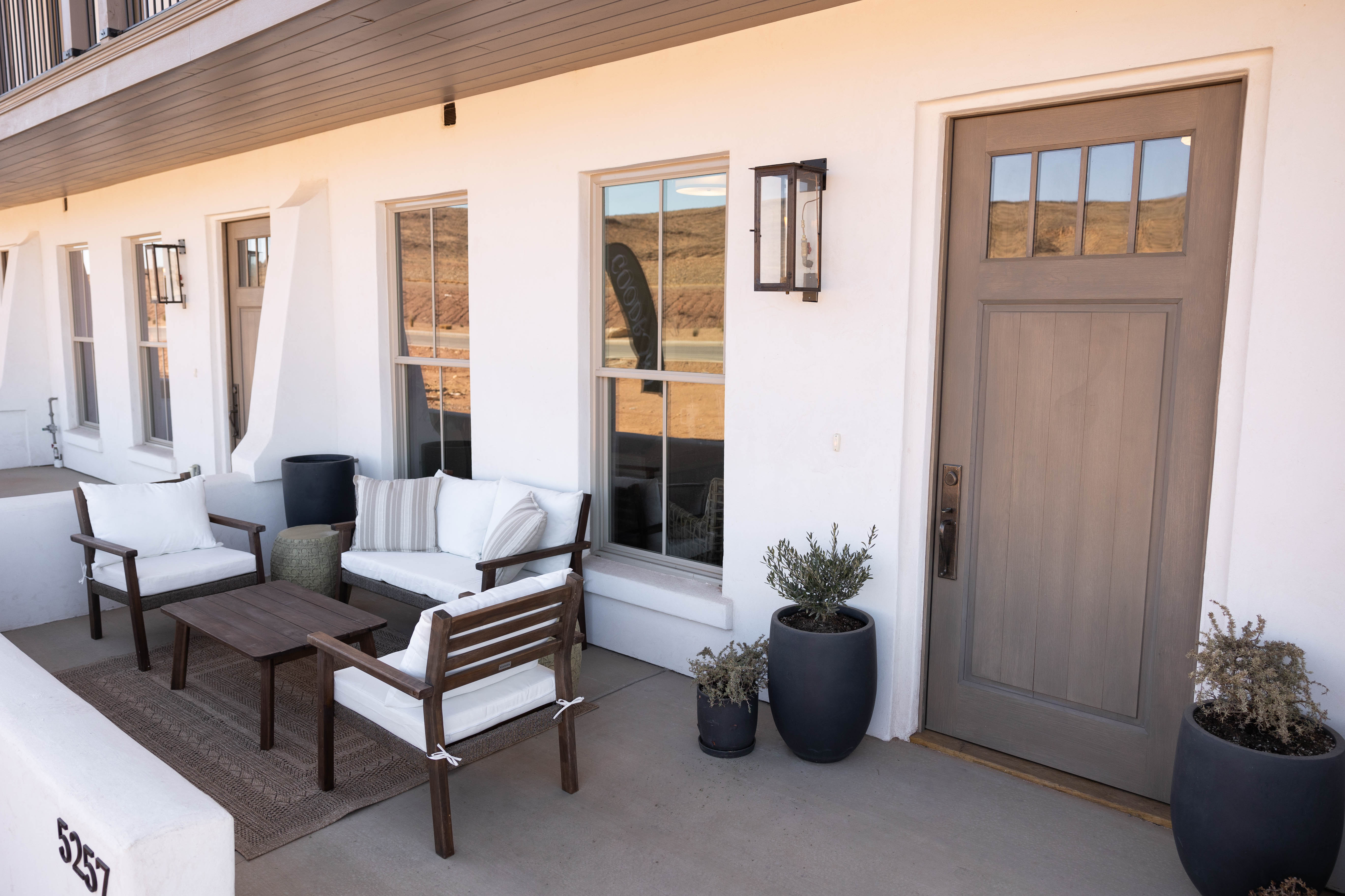 Front entrance with a gray wood-finish door featuring divided lites