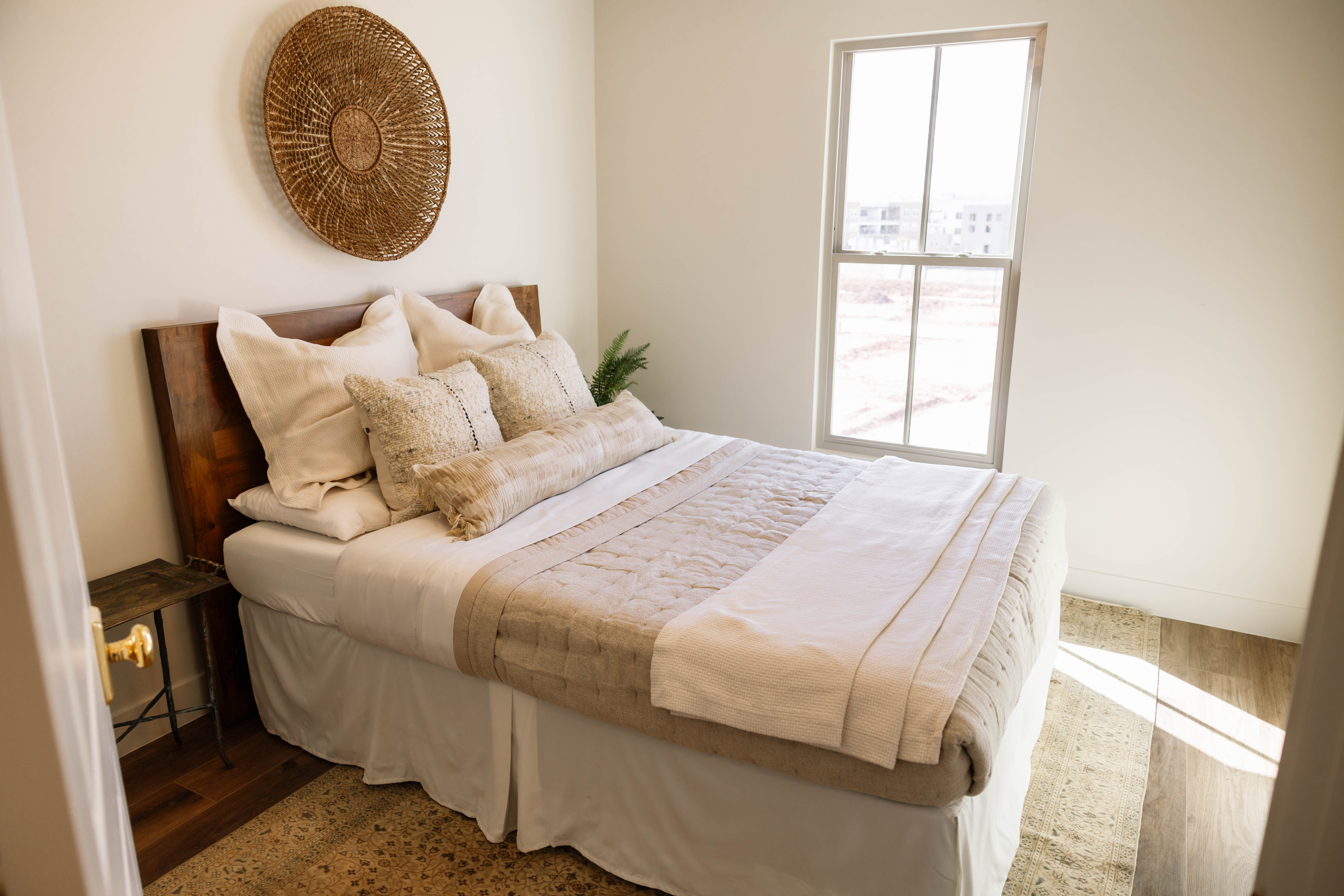 Bedroom featuring a tall window, a wood-finish headboard, and wood-finish flooring