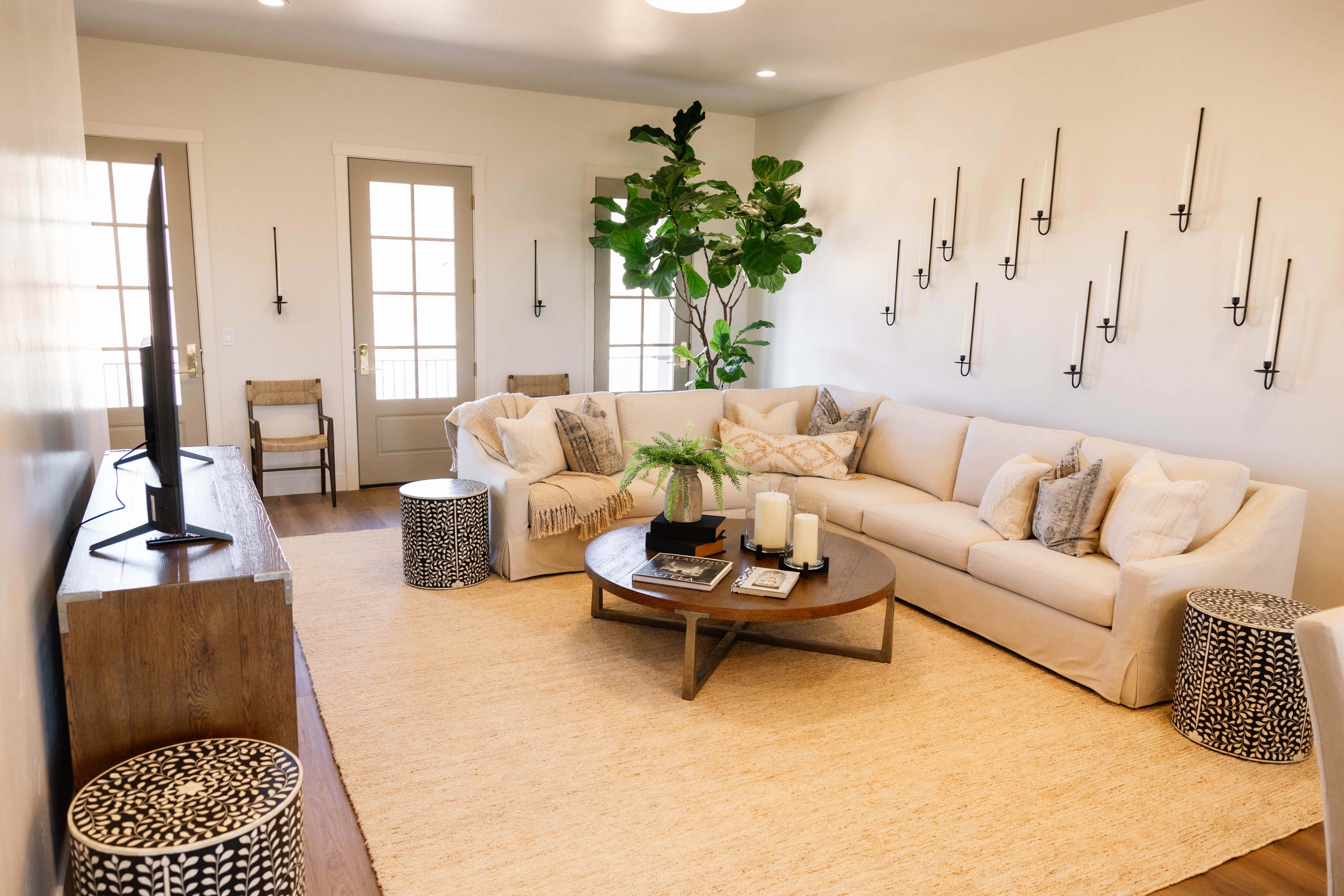 Living area featuring light wood-finish flooring and a light-toned area rug