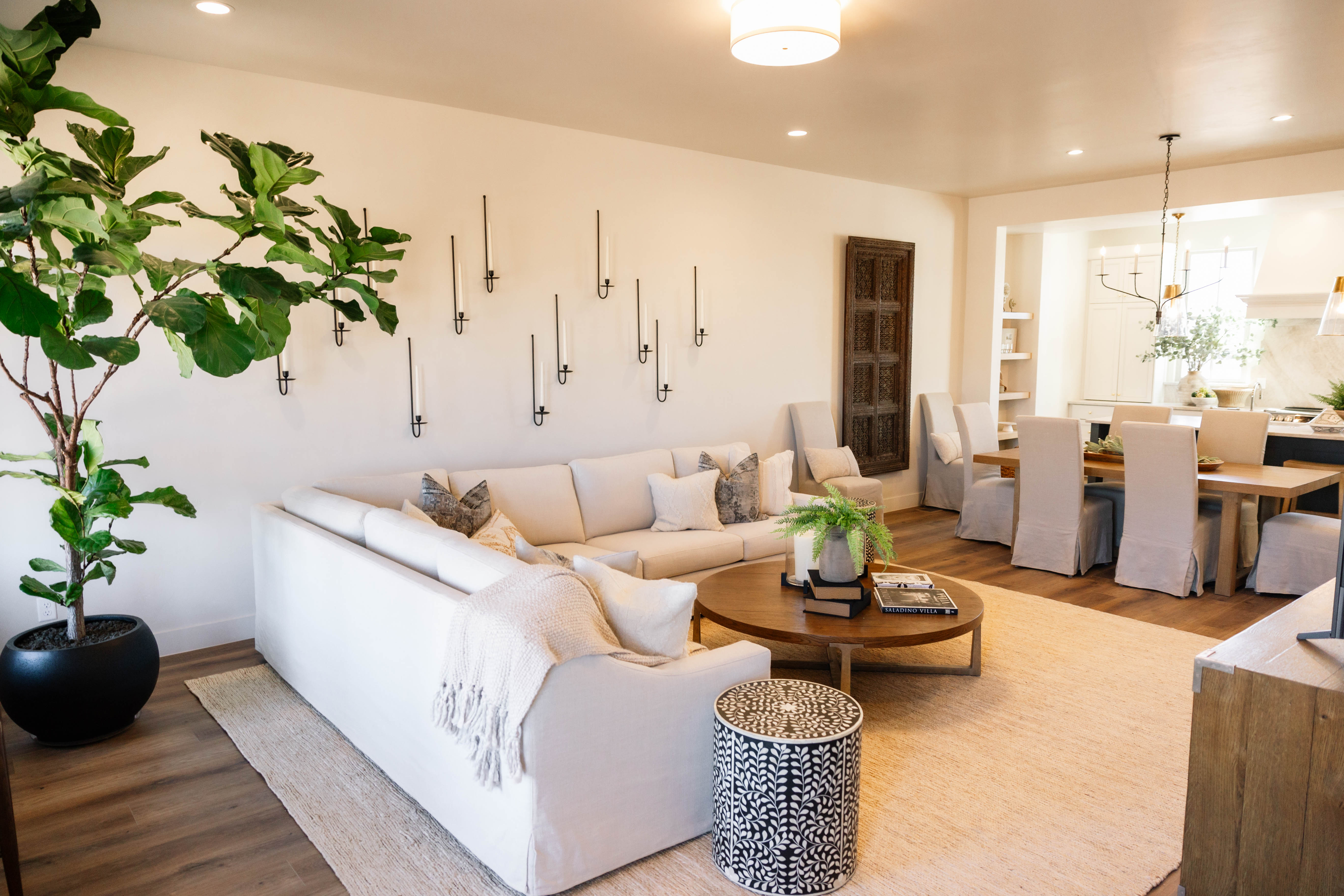 Open-concept living space featuring wood-finish flooring, recessed lighting, and a neutral color palette