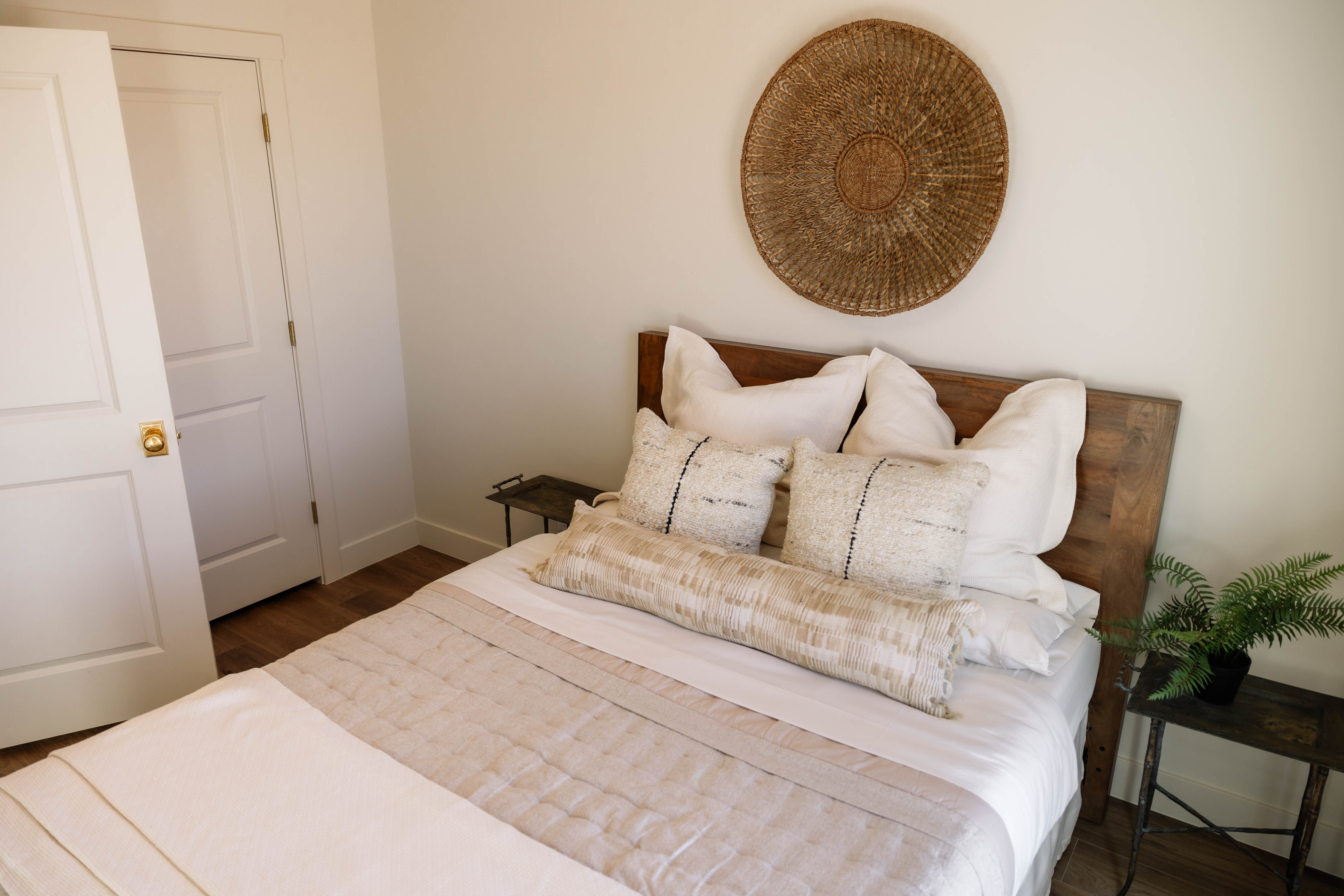Bedroom featuring wood-finish flooring and a solid wood headboard