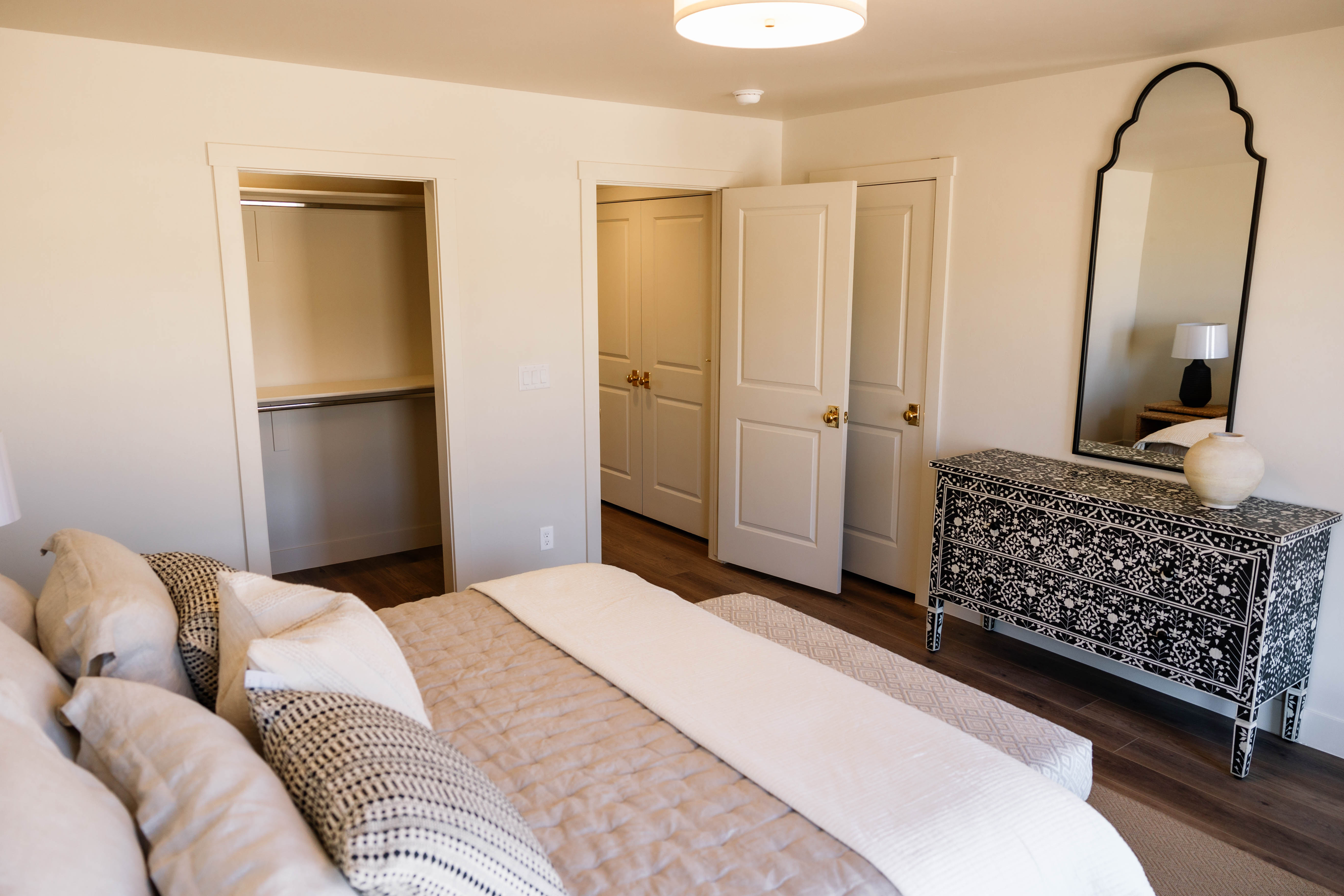 Interior room featuring wood-finish flooring, light-toned walls, and a ceiling-mounted flush light fixture