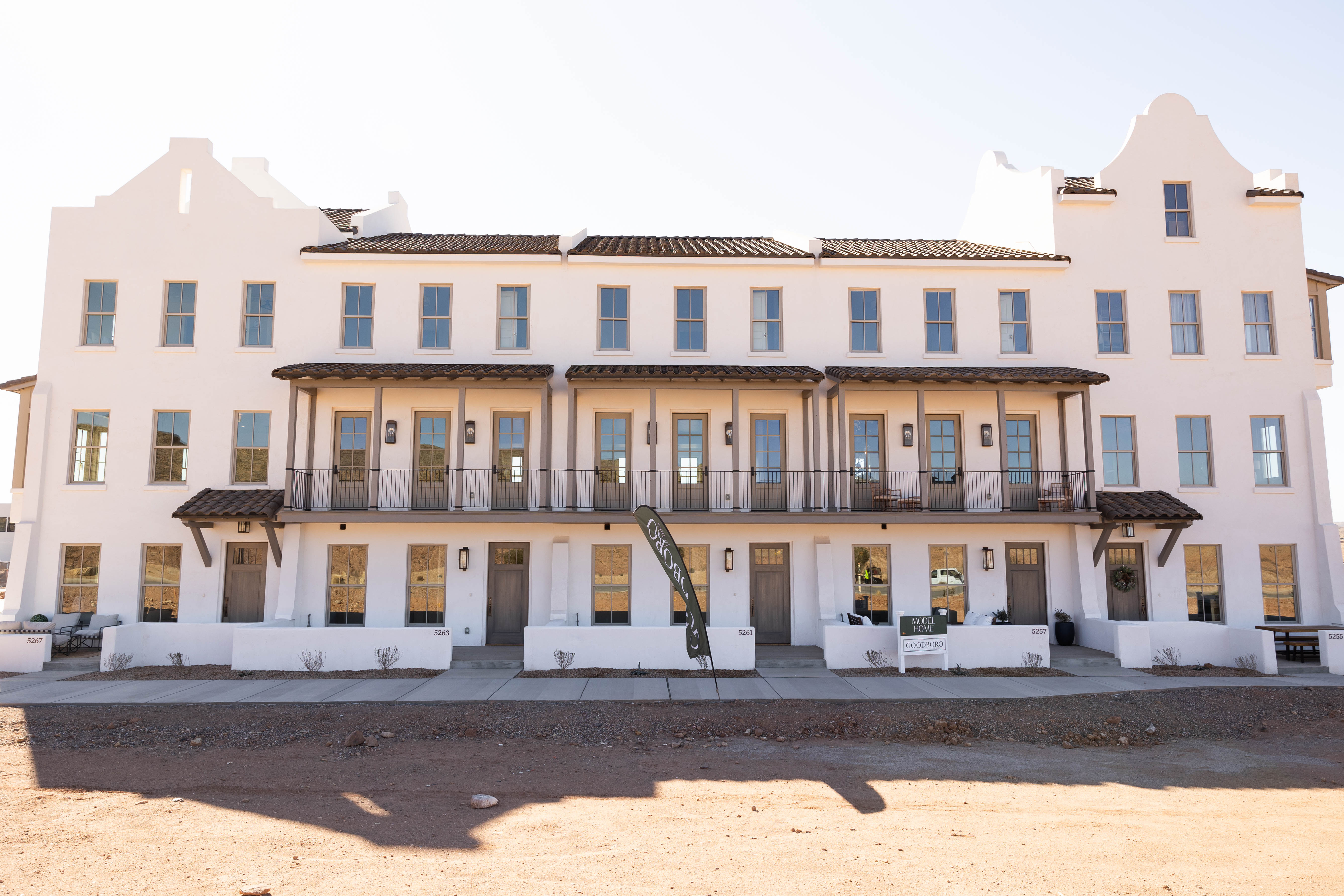 Spanish Colonial style multi-story building featuring white stucco exterior and tile roofing