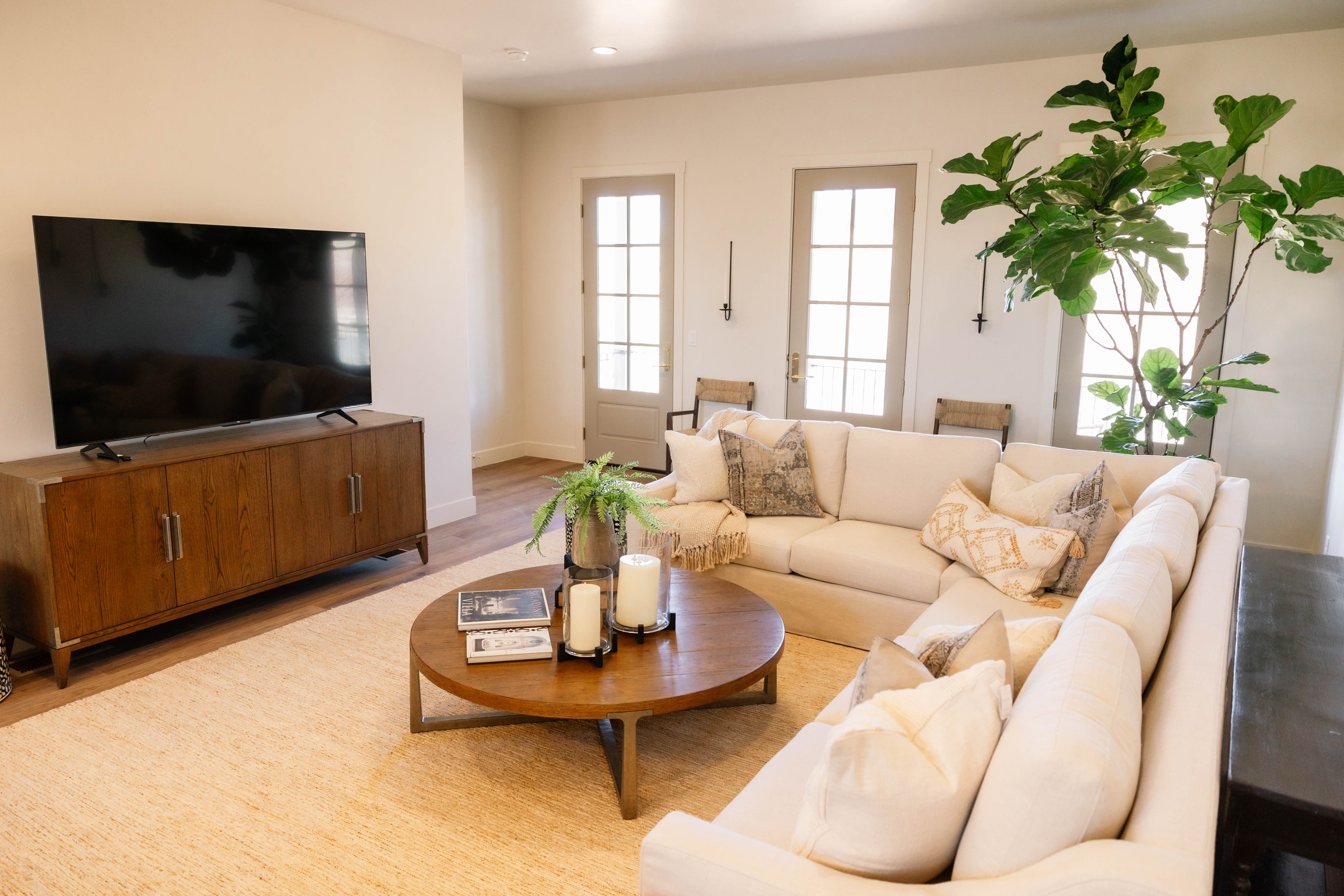 Bright living space featuring warm-toned wood-finish flooring
