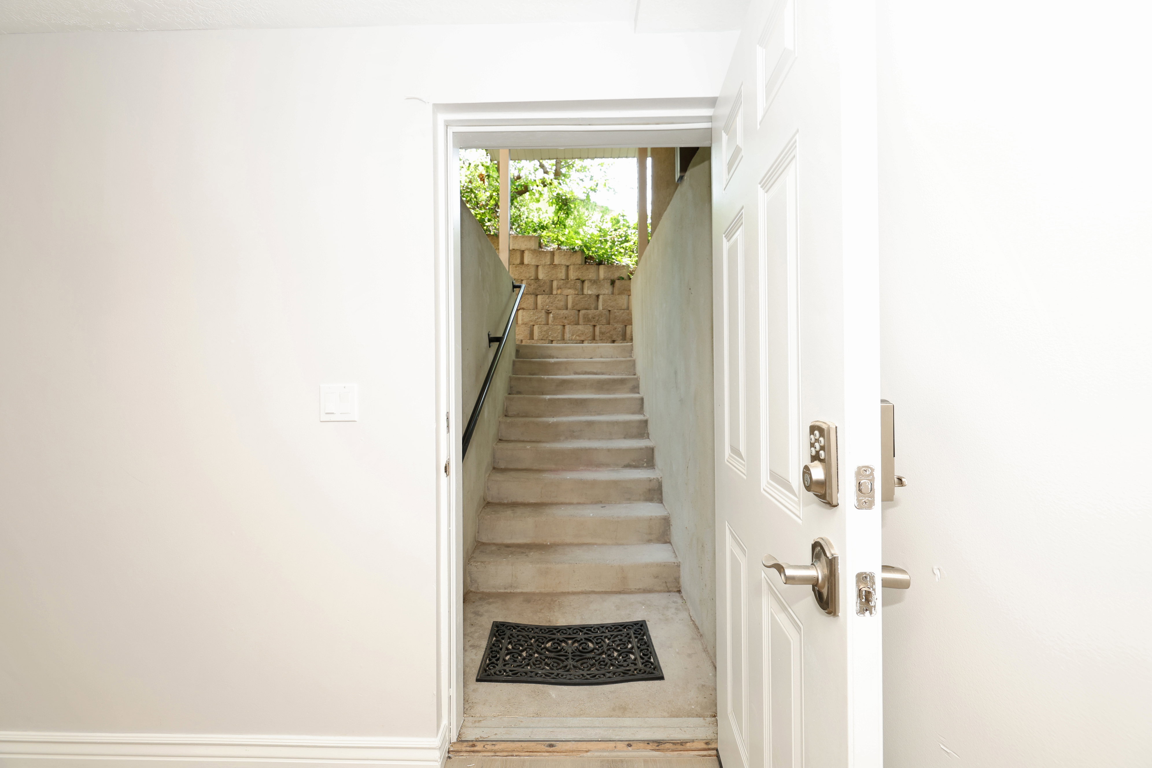 Solid core entry door with brushed nickel hardware and a keyless entry system