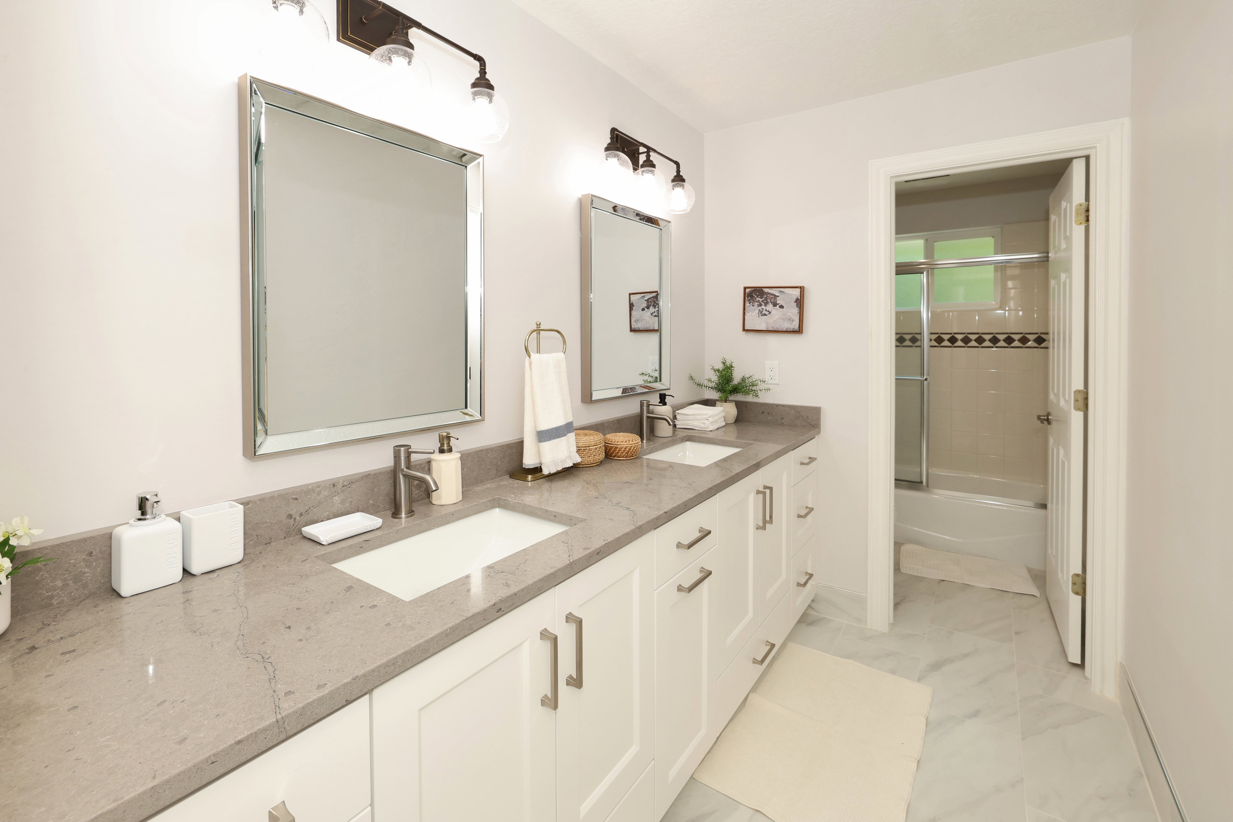 Dual vanity with light gray countertop and integrated rectangular sinks