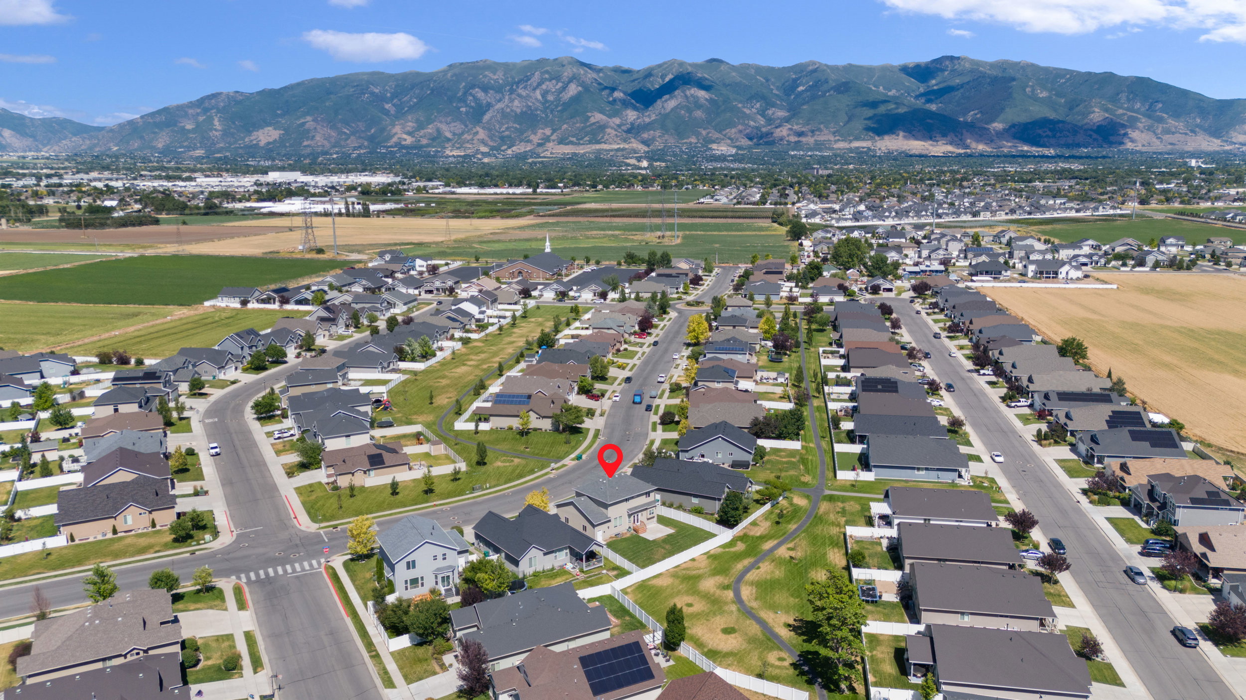 Aerial perspective showcasing a residential neighborhood with mountain backdrop
