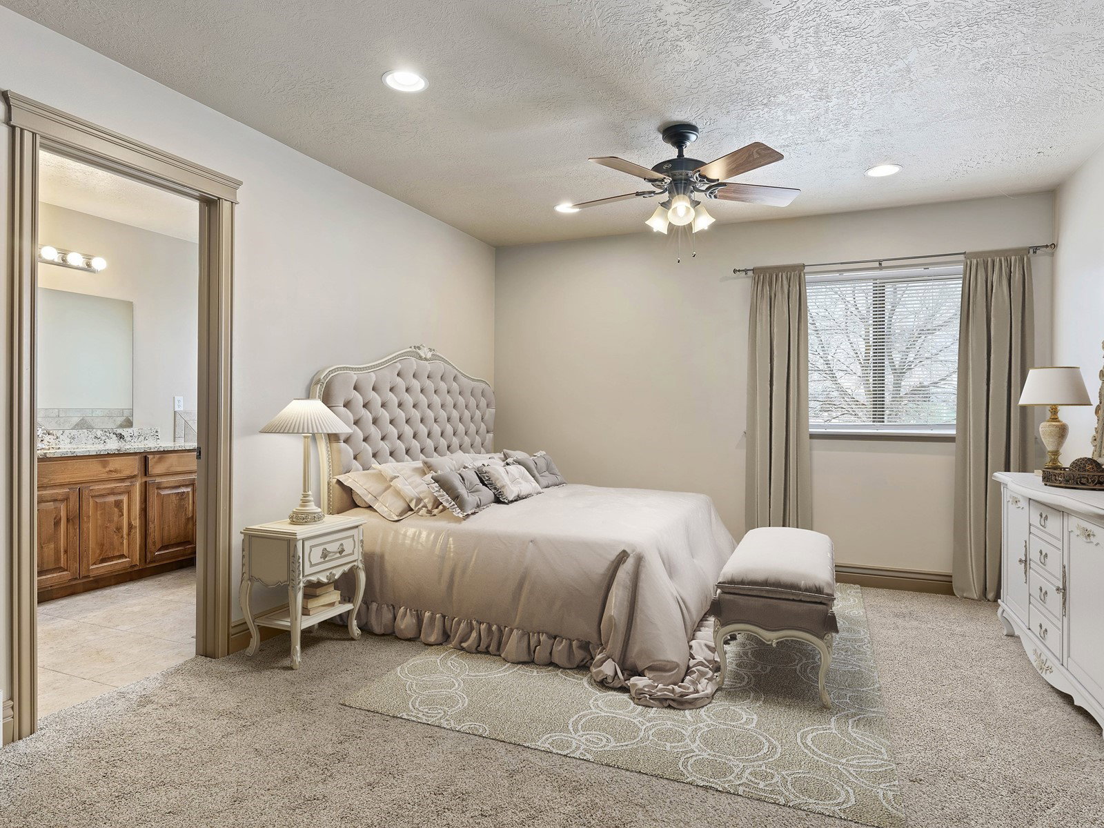 Carpeted bedroom featuring a ceiling fan with integrated lighting, a window with curtains, and recessed lighting