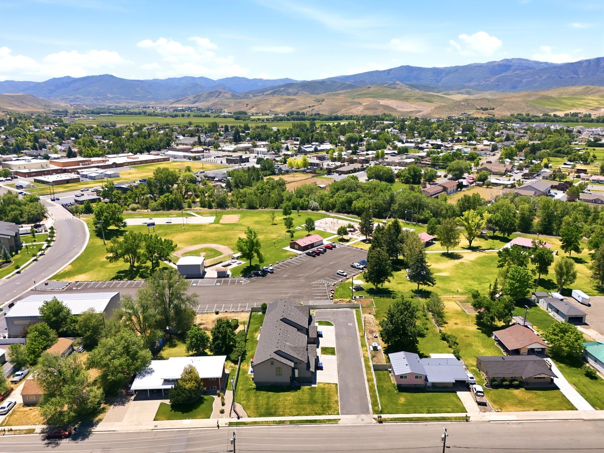Aerial perspective showcasing the surrounding community with distant mountain ranges
