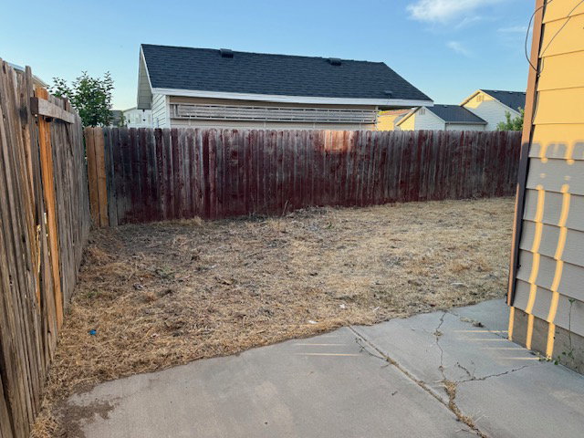 Fenced backyard with concrete patio space
