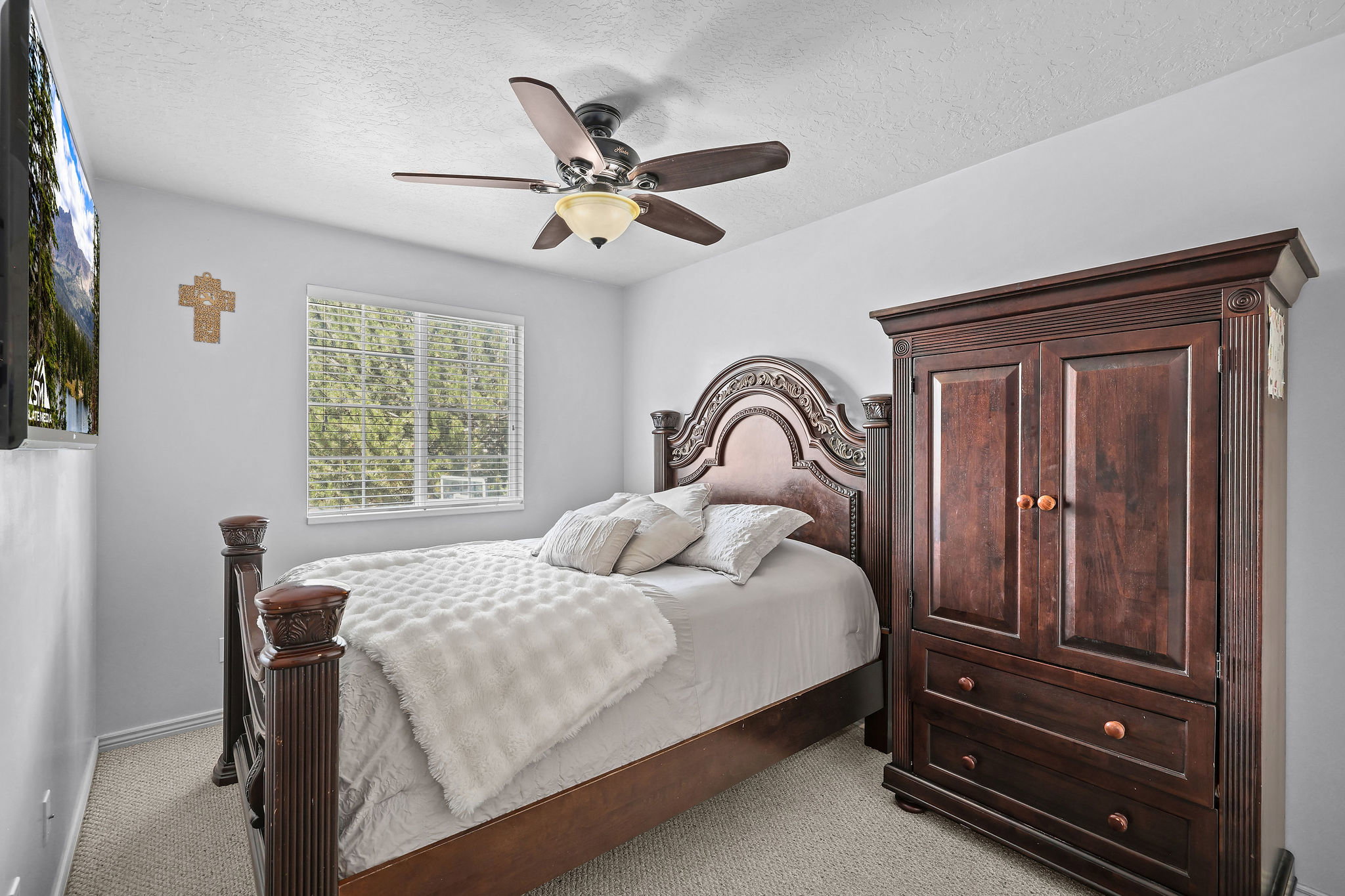 Bedroom featuring carpet flooring, a window with blinds, and a ceiling fan