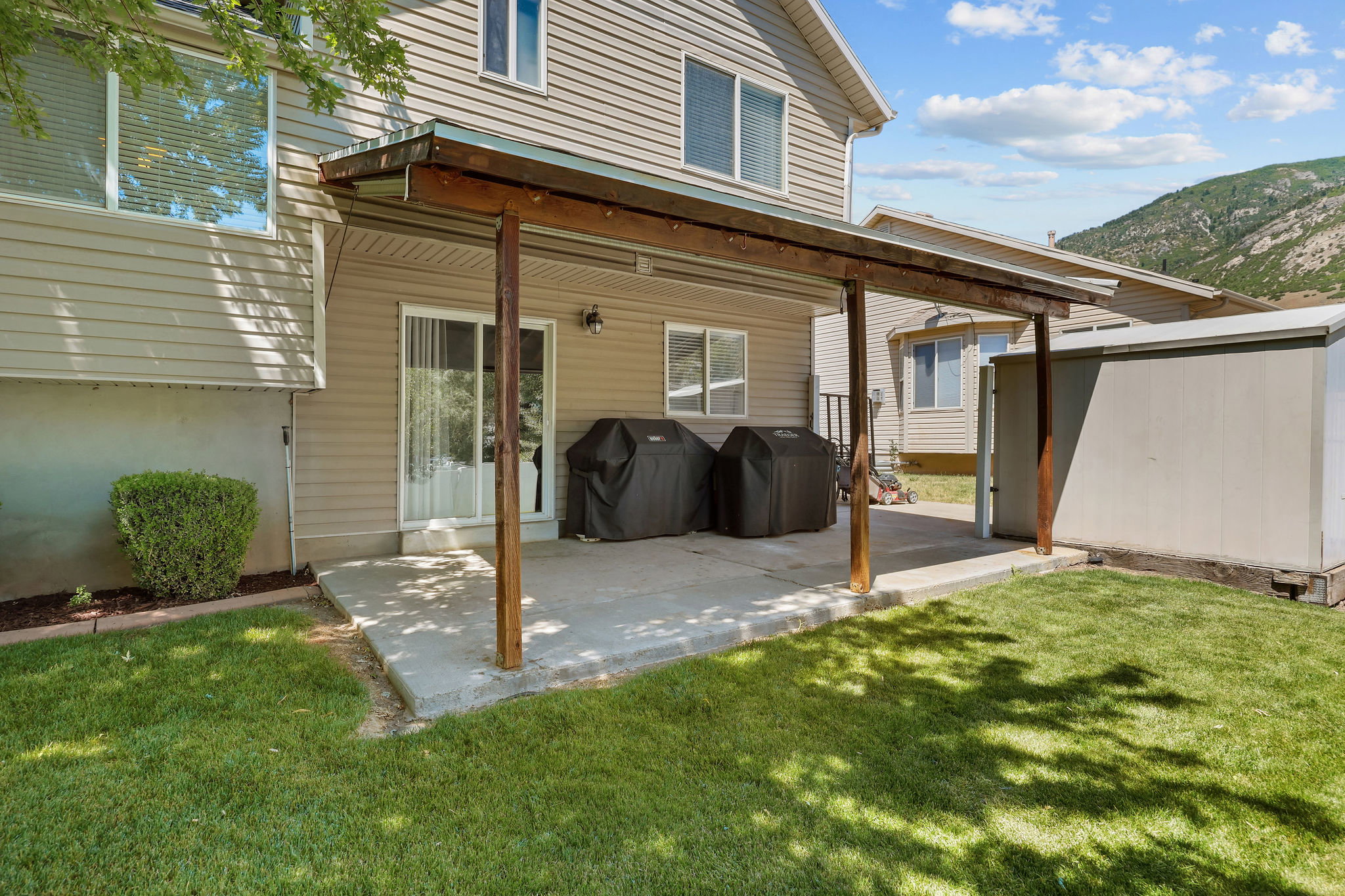 Covered concrete patio with direct access to interior via sliding glass door