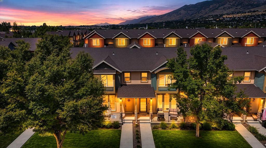 Contemporary townhome exterior featuring multi-toned siding and pitched roofs