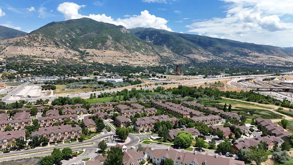 Aerial perspective of a community featuring numerous residential townhomes and single-family residences