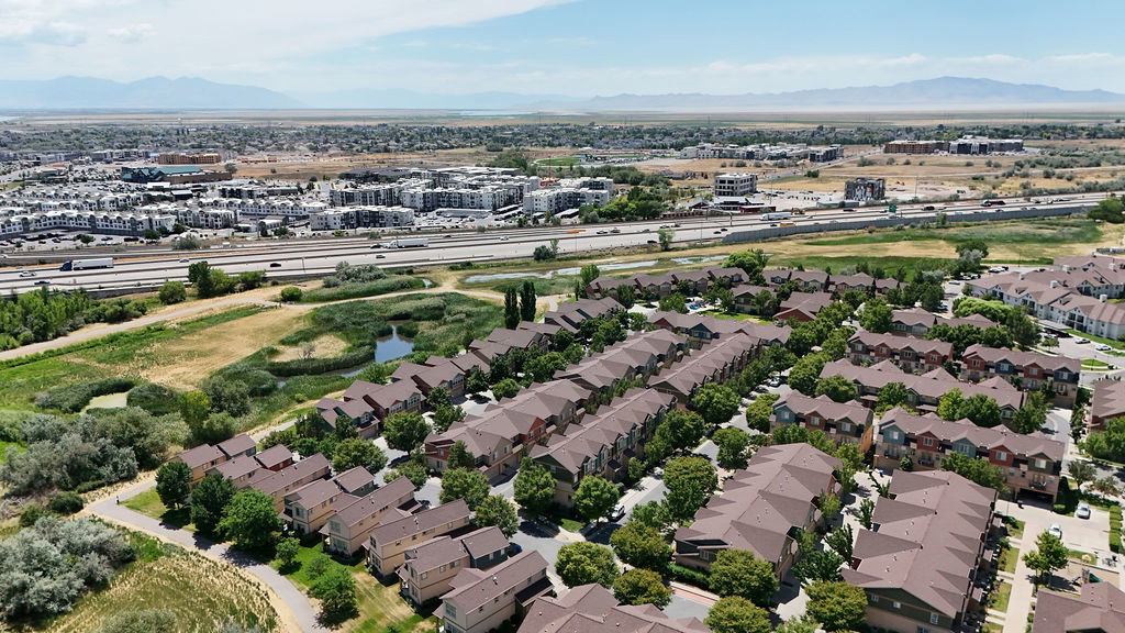 Aerial perspective showcasing a residential development with multiple townhome-style buildings