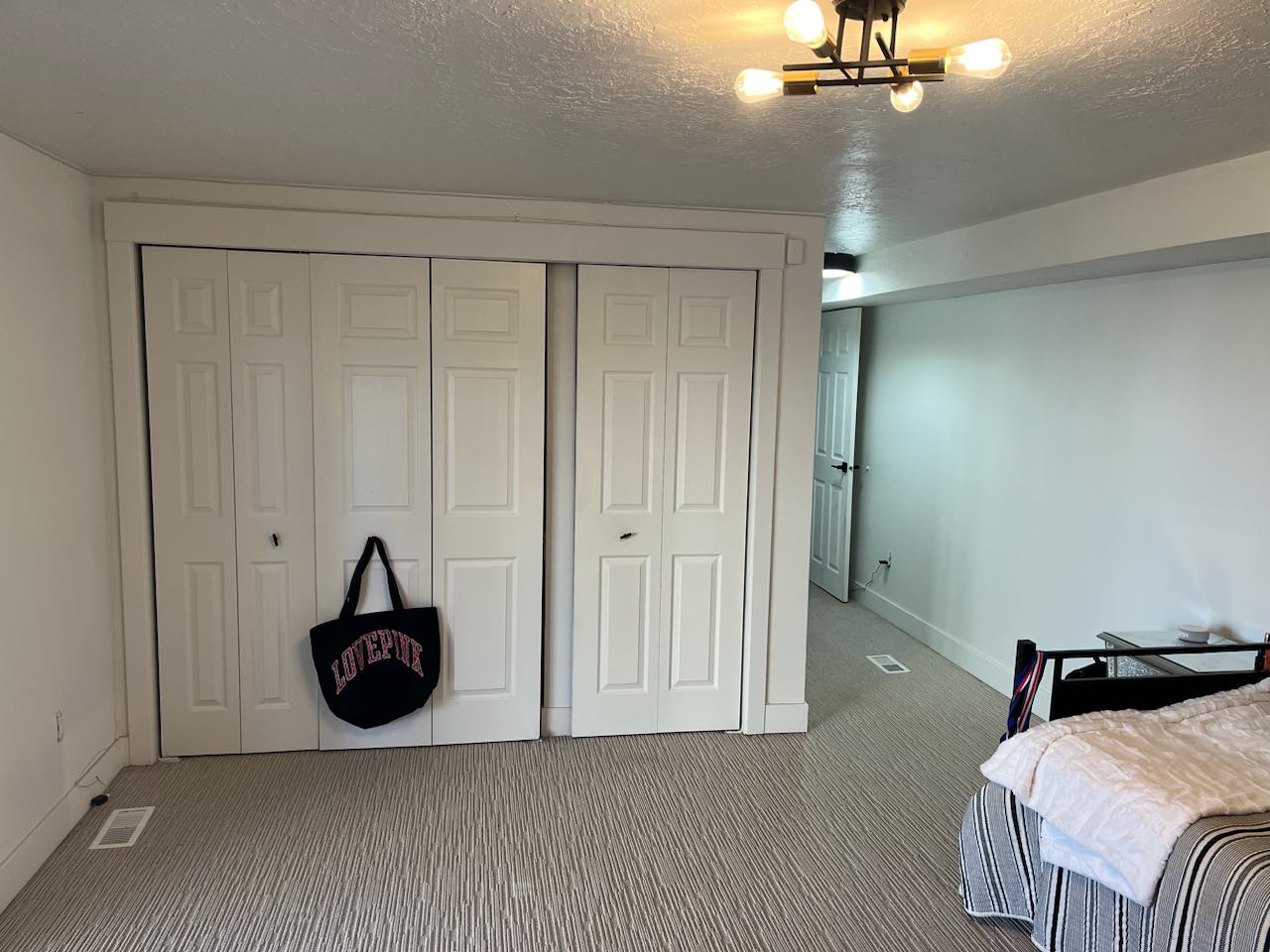 White paneled bi-fold closet doors with substantial trim