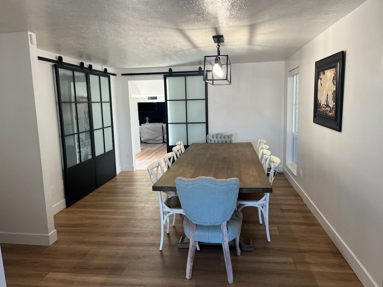 Dining area featuring wood-finish flooring, white walls, and a recessed window