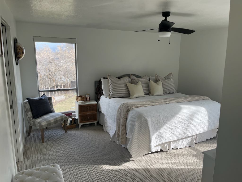 Spacious room featuring light-toned walls and textured carpeting