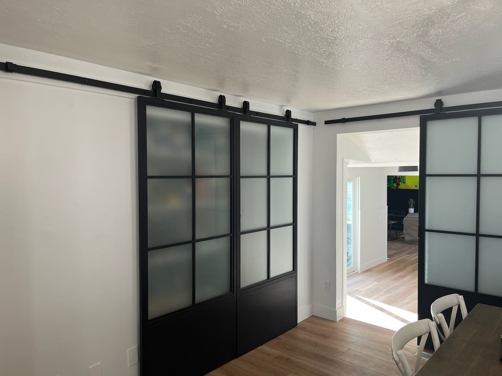 Black-framed sliding doors with frosted glass panels