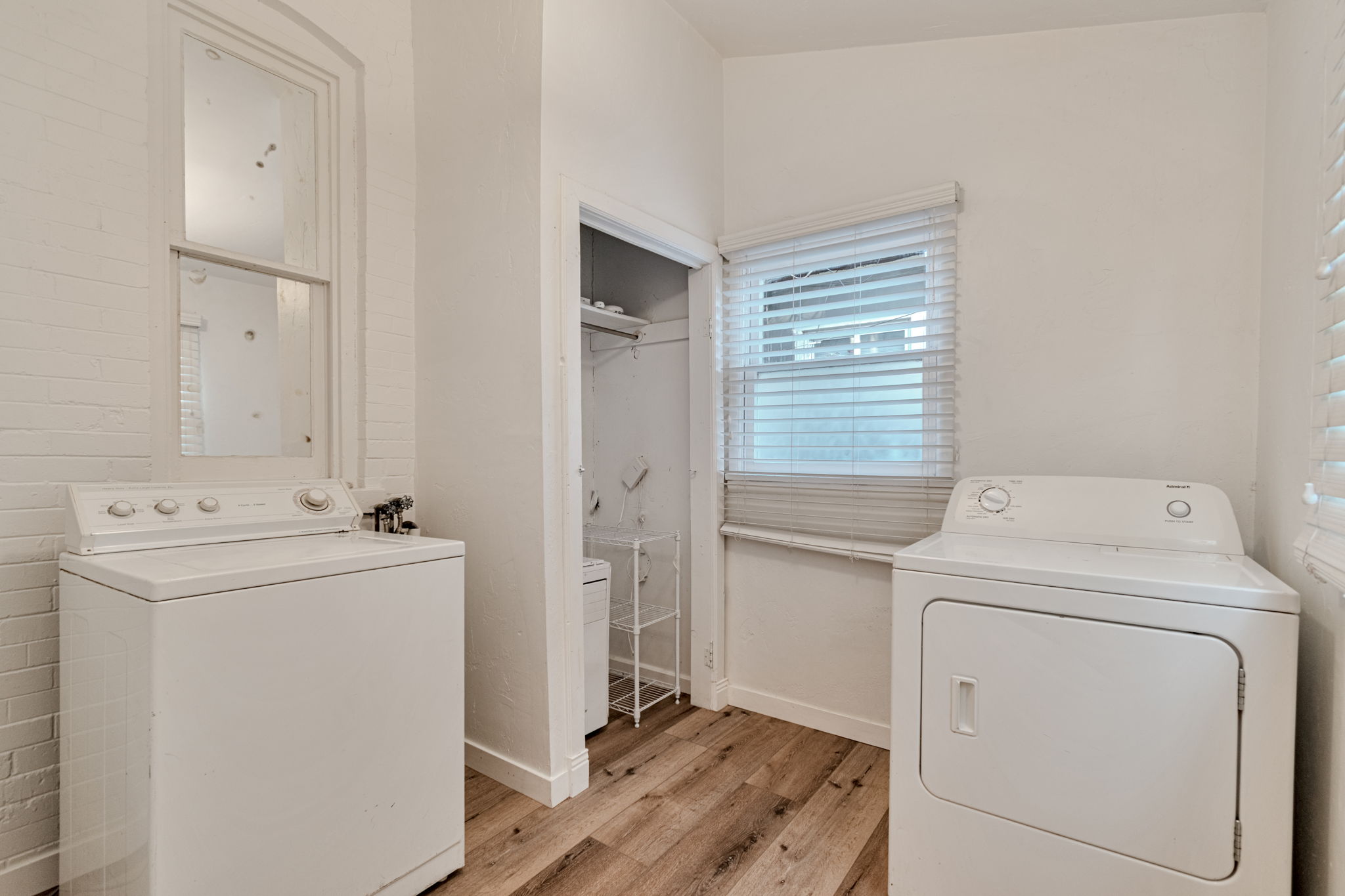 Laundry room with storage closet.