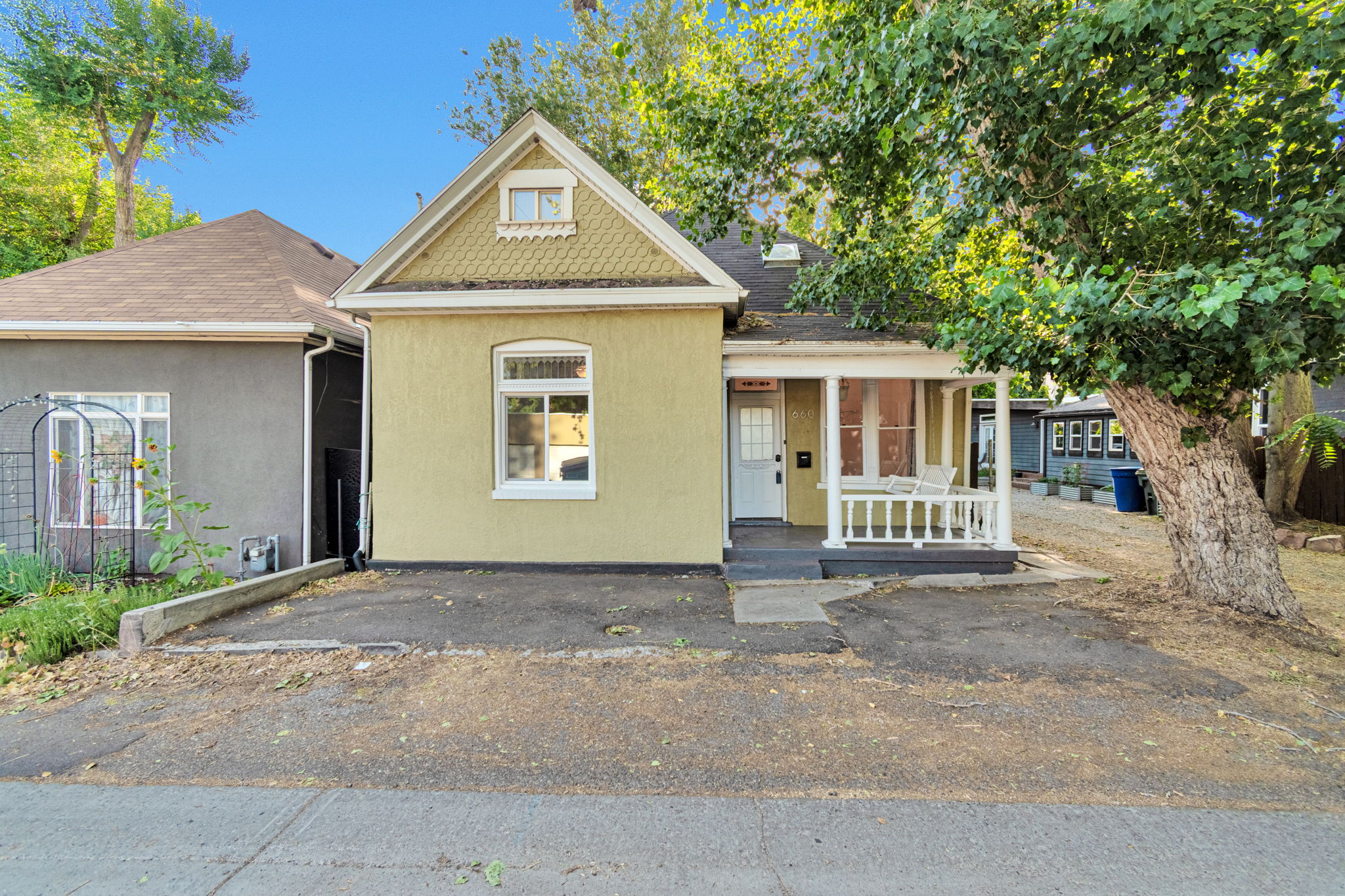Charming yellow stucco exterior with front porch. Off street parking in front.