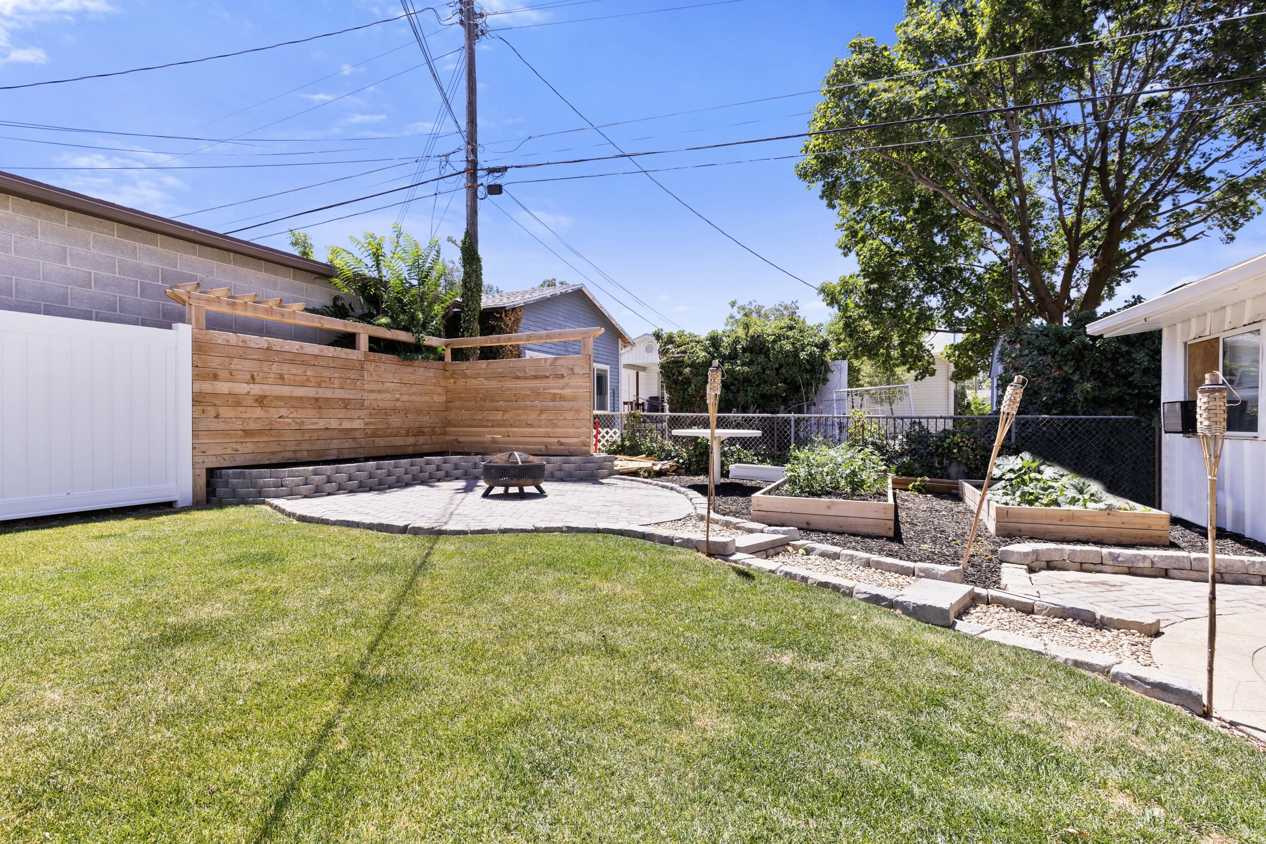 Expansive backyard featuring a lush lawn, a