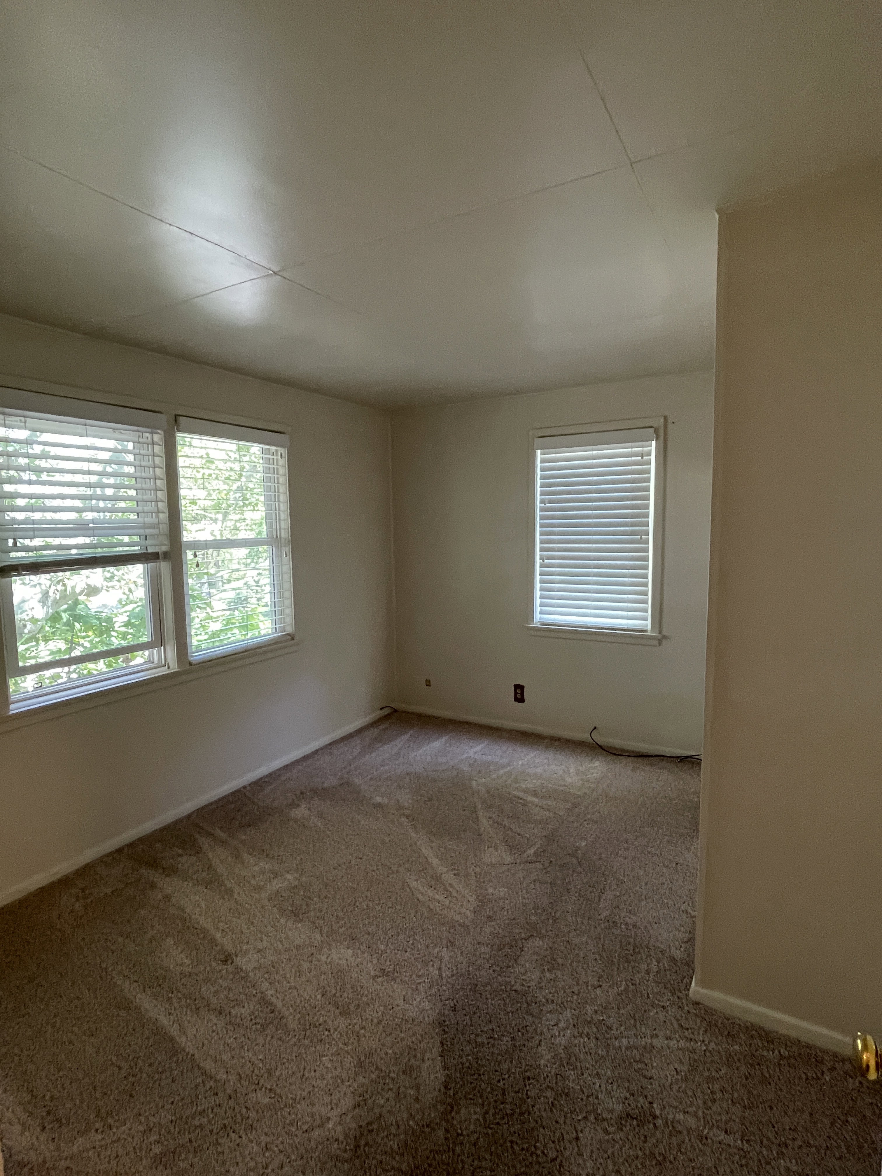 Room featuring neutral wall finishes and patterned carpeting