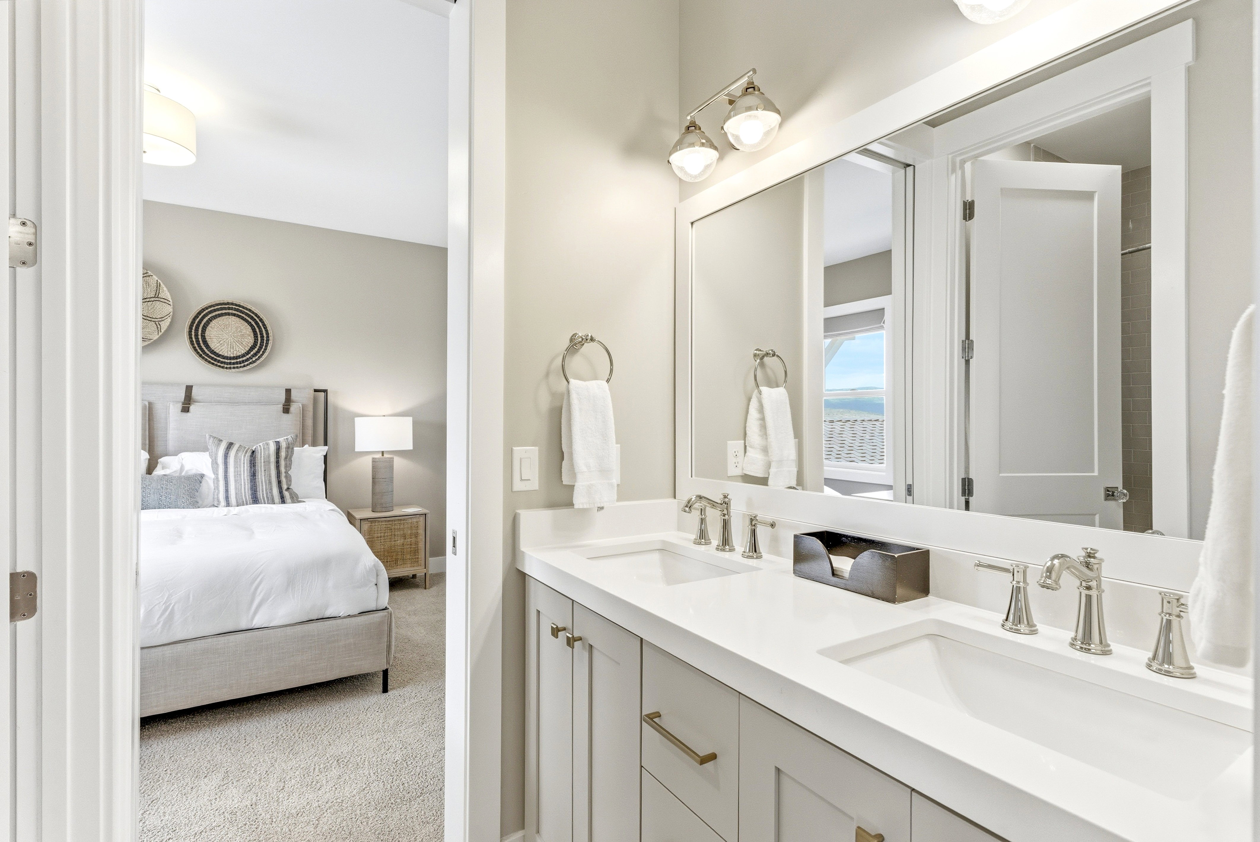 Double vanity with light gray cabinetry, brushed nickel hardware, and dual undermount sinks