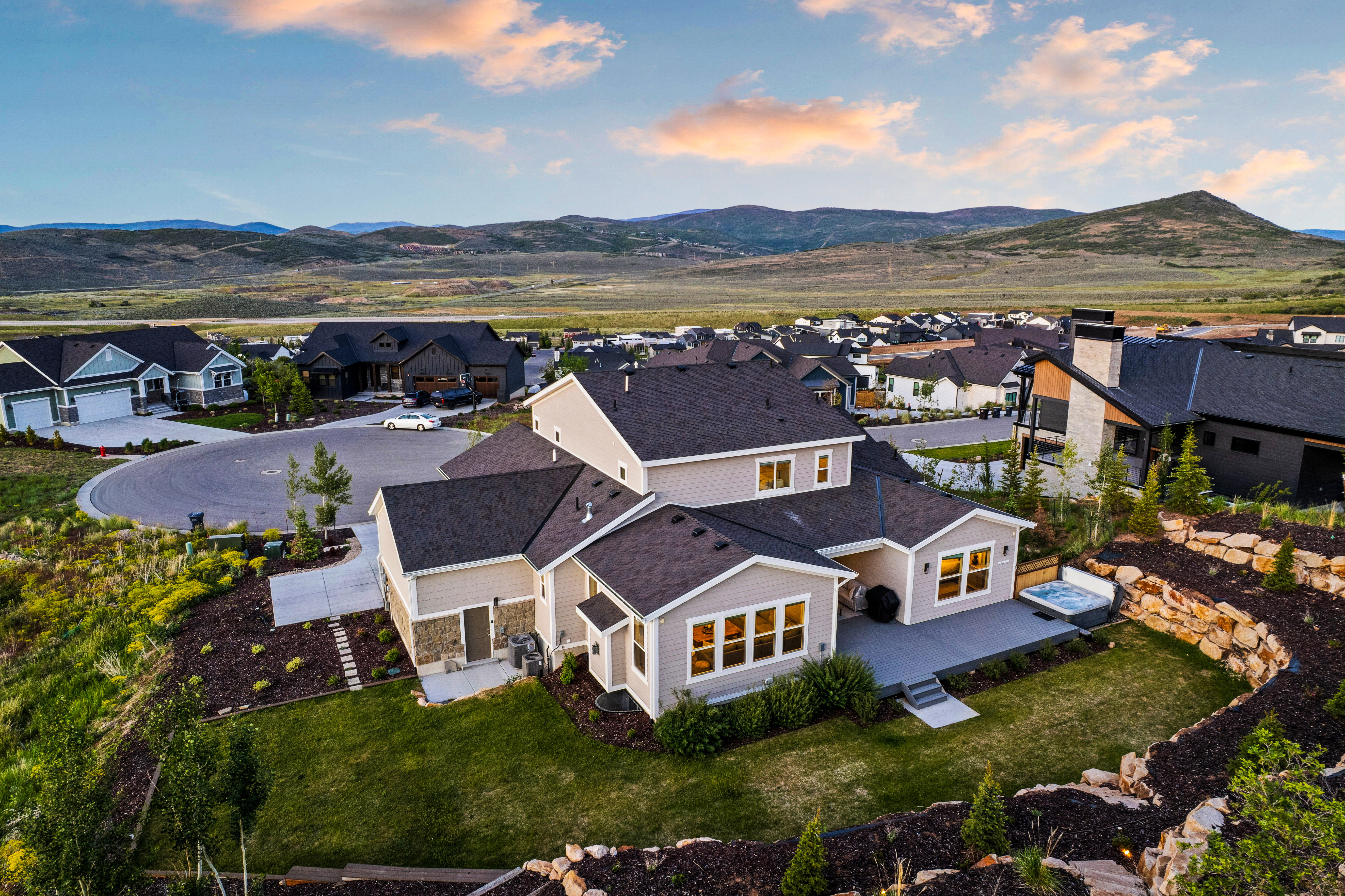 Contemporary residence featuring a multi-level composite deck with an integrated hot tub