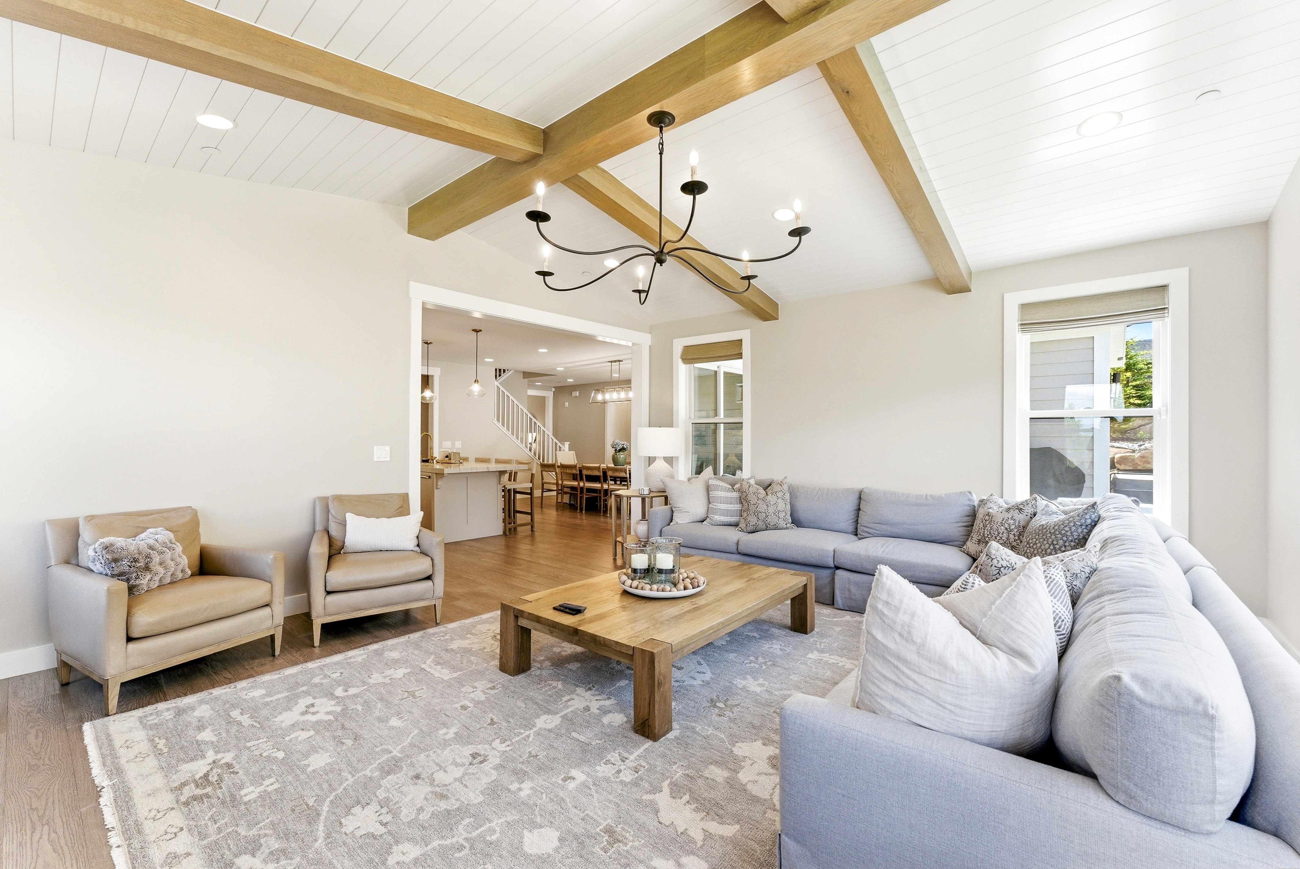 Vaulted ceiling with exposed wood beams and white plank detailing