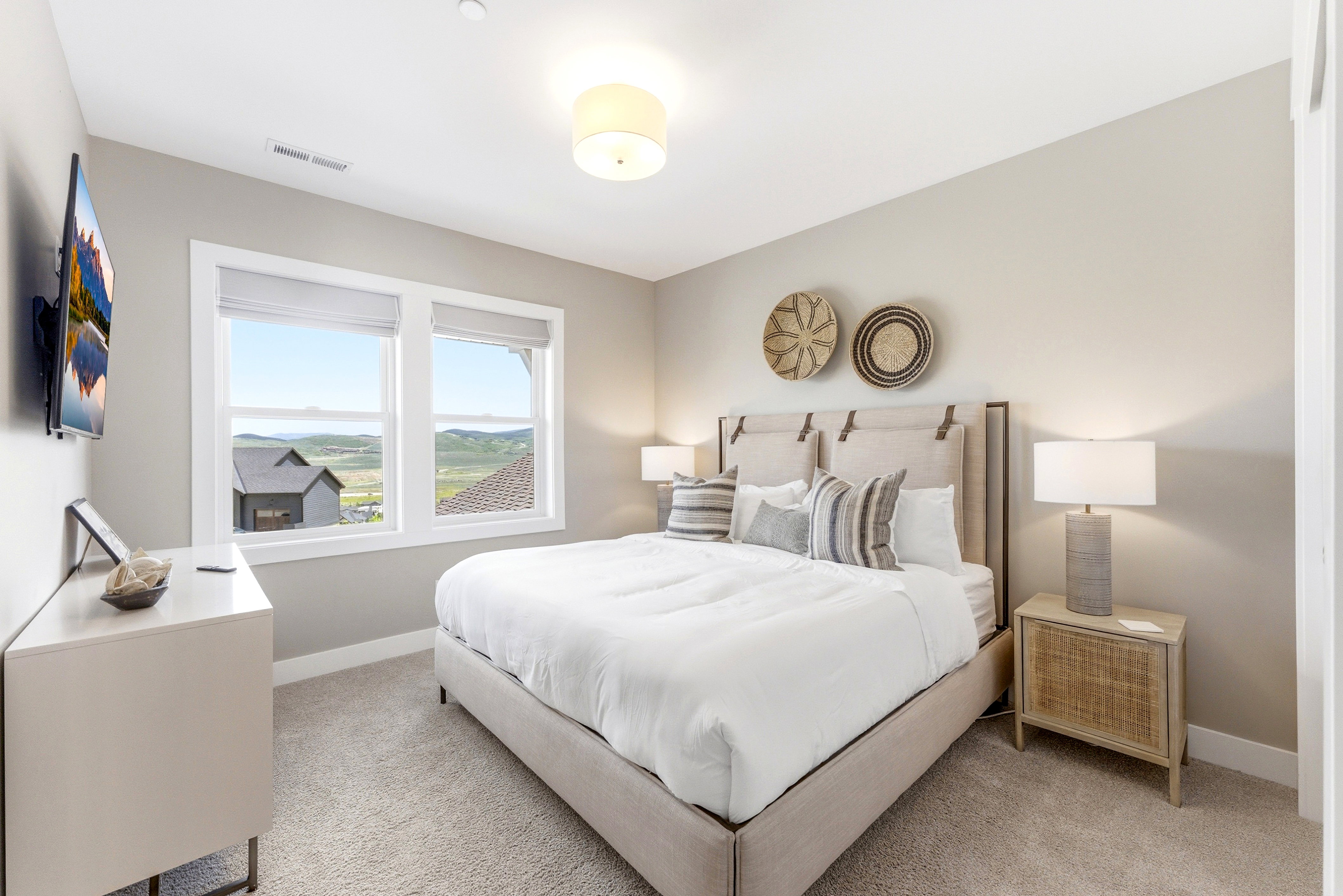 Recessed lighting and a flush mount ceiling fixture illuminate this carpeted room