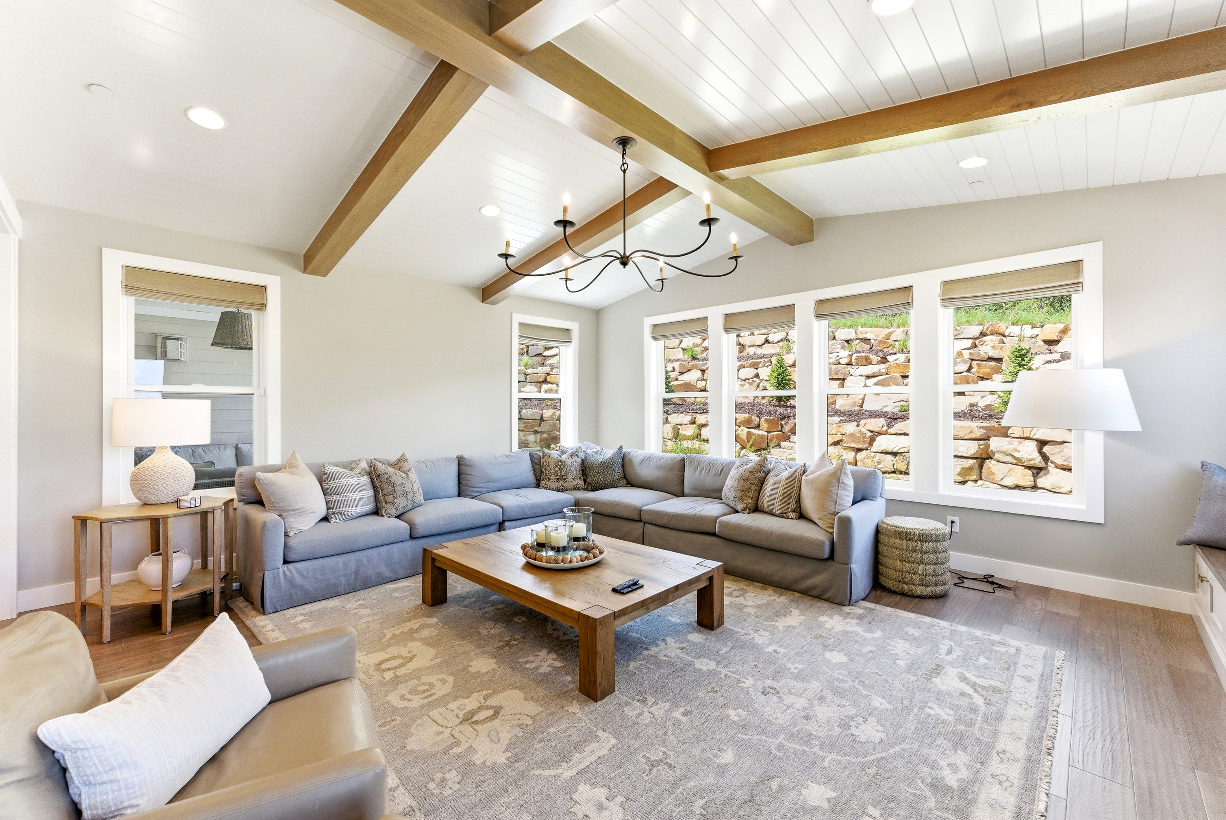Vaulted ceiling featuring exposed wood beams and shiplap paneling