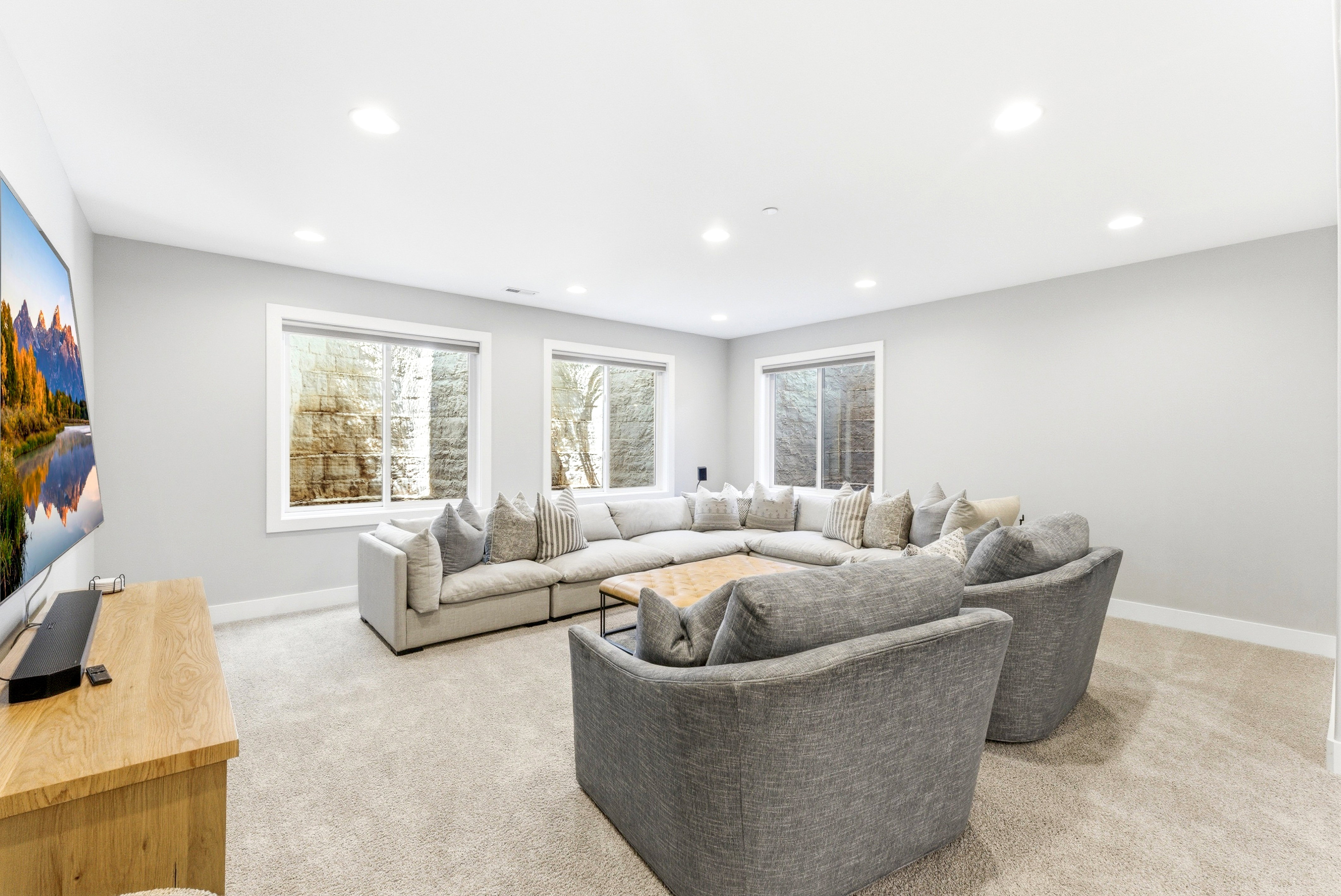 Spacious room featuring light gray wall paint and recessed ceiling lighting