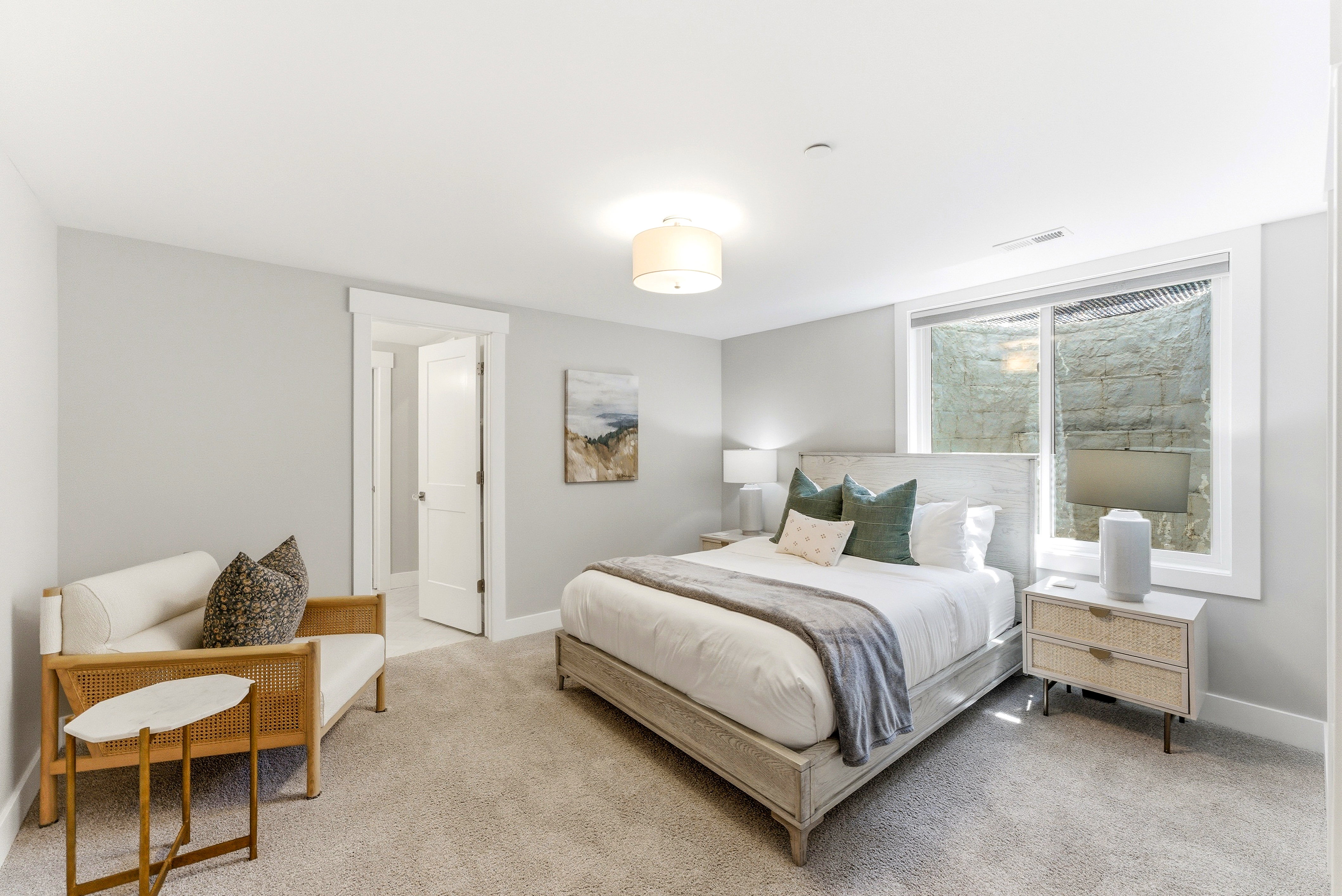 Carpeted room with a ceiling-mounted drum light fixture and light gray wall paint