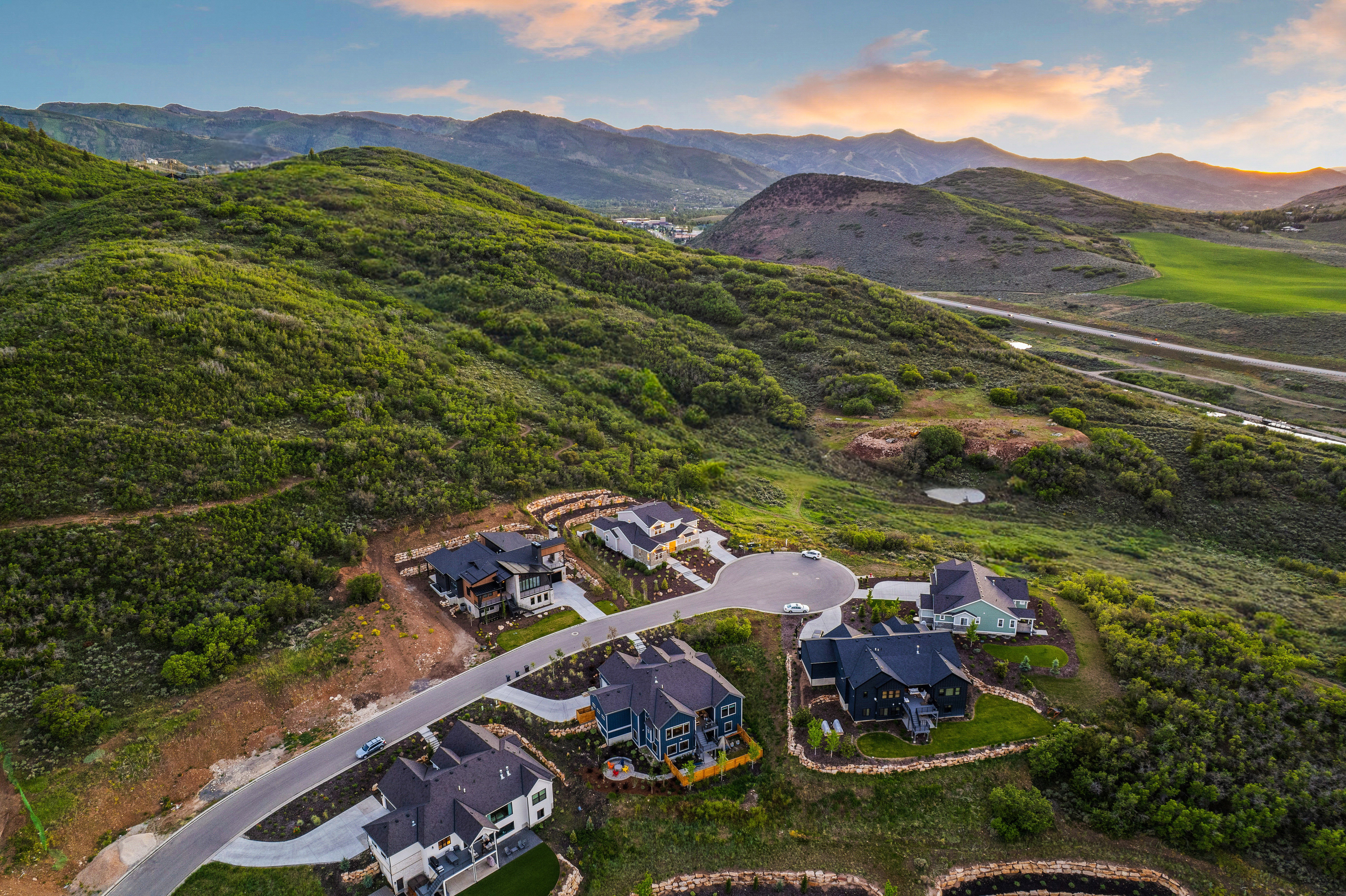Hillside residential development featuring custom-built homes with varied architectural styles