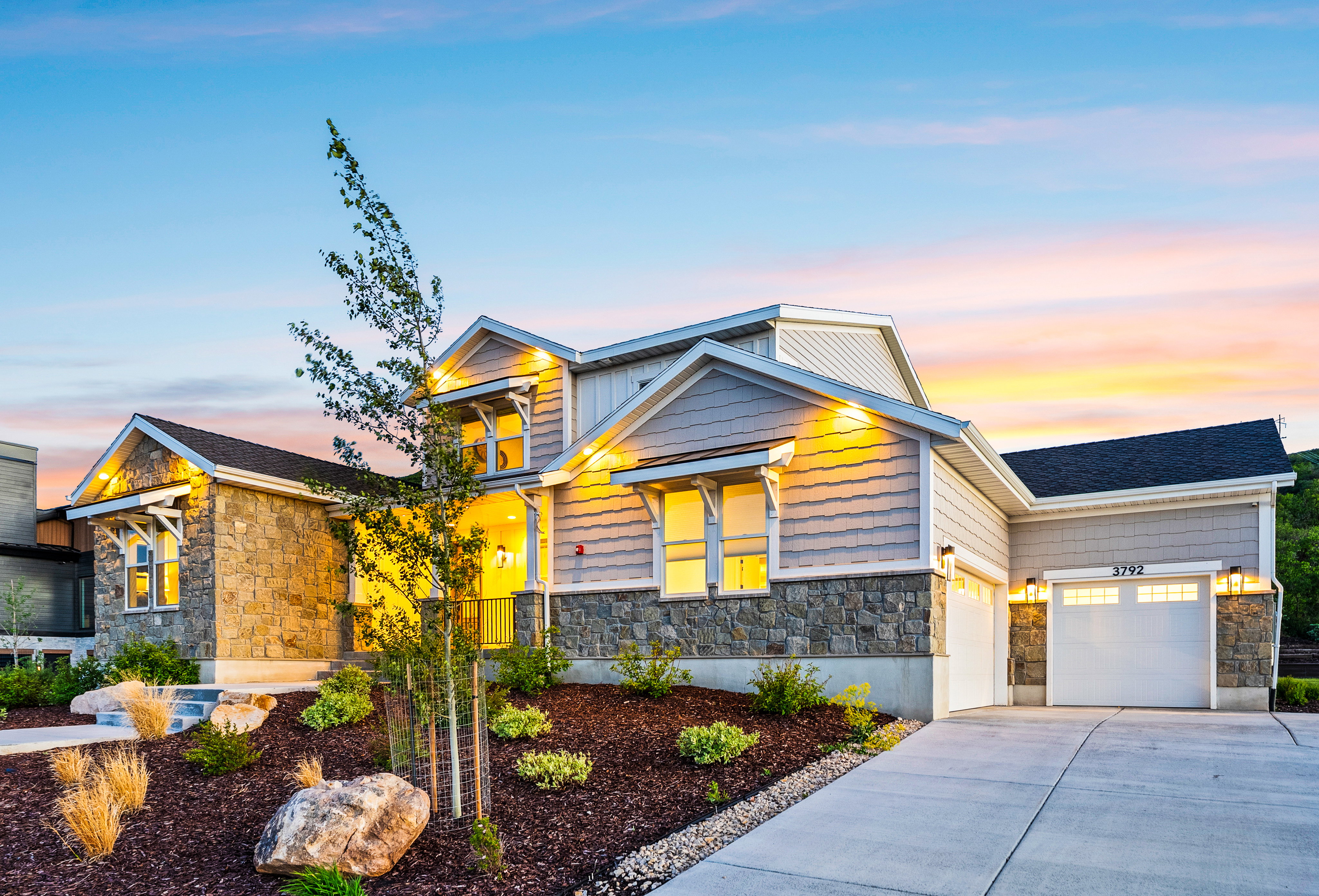 Contemporary home exterior featuring stone and horizontal siding