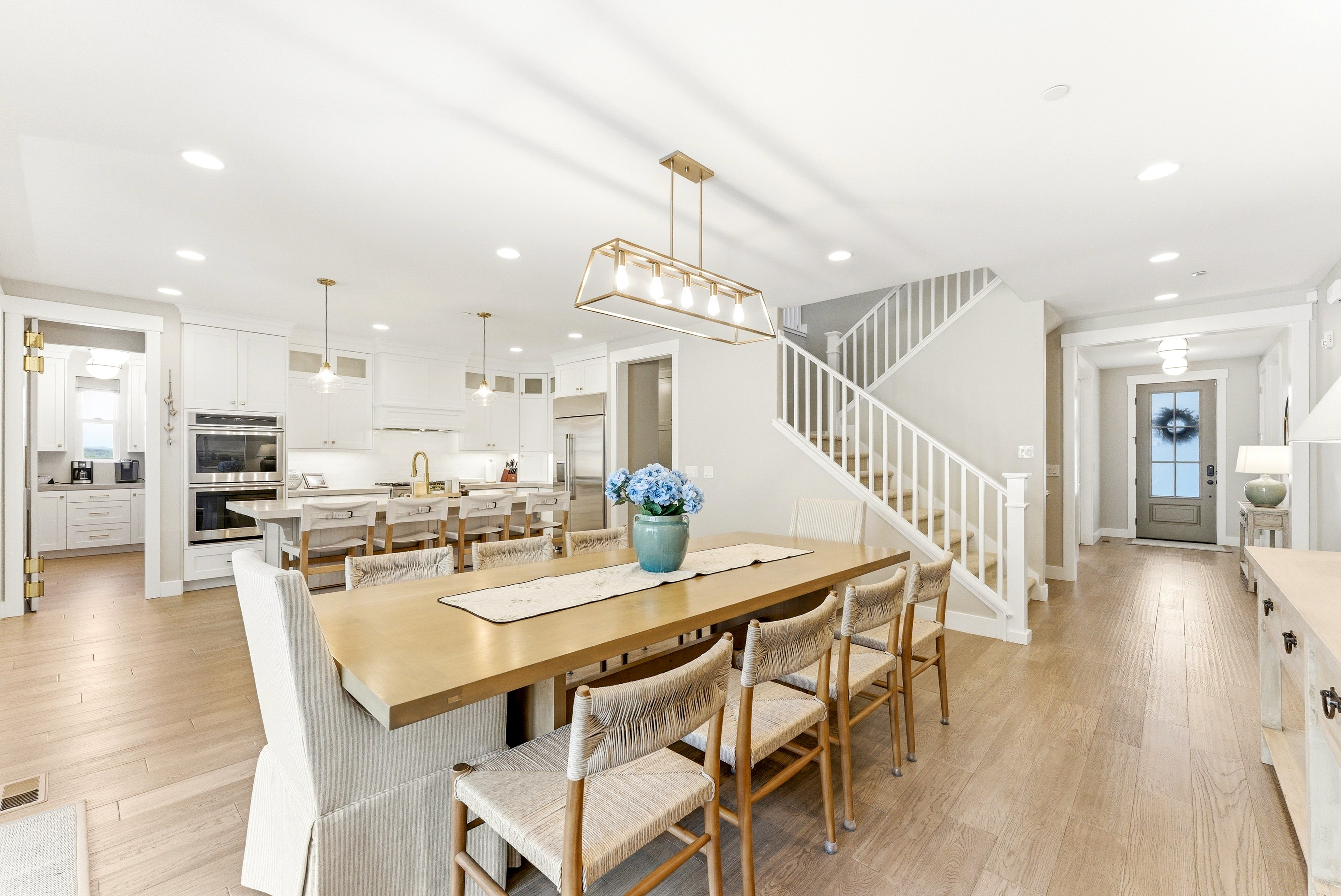 Open-concept living area with light wood-finish flooring