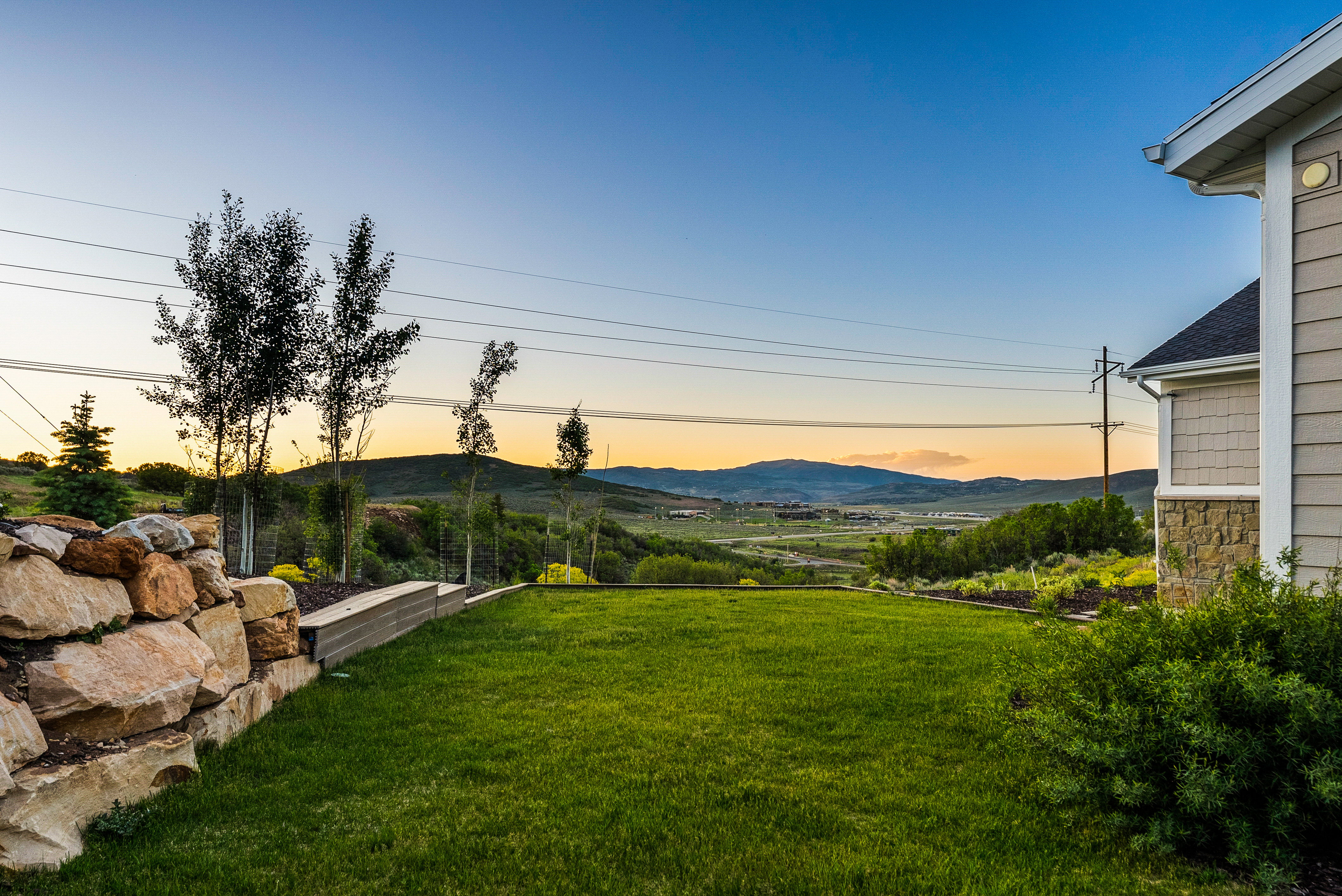 Expansive green lawn with mountain backdrop