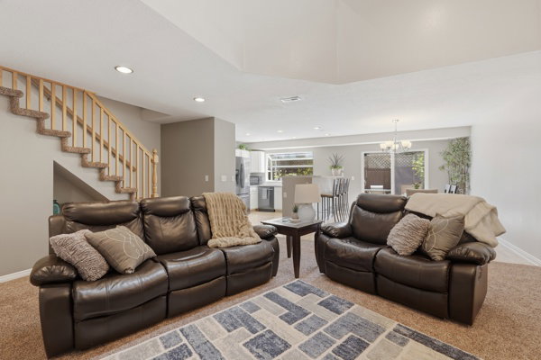 Open-concept living area with neutral wall tones and recessed lighting