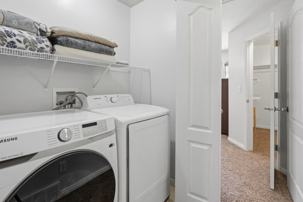 Dedicated laundry area featuring a white front-load washer and dryer