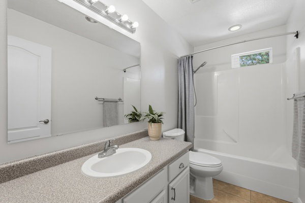 Bathroom vanity with a composite countertop and integrated white sink