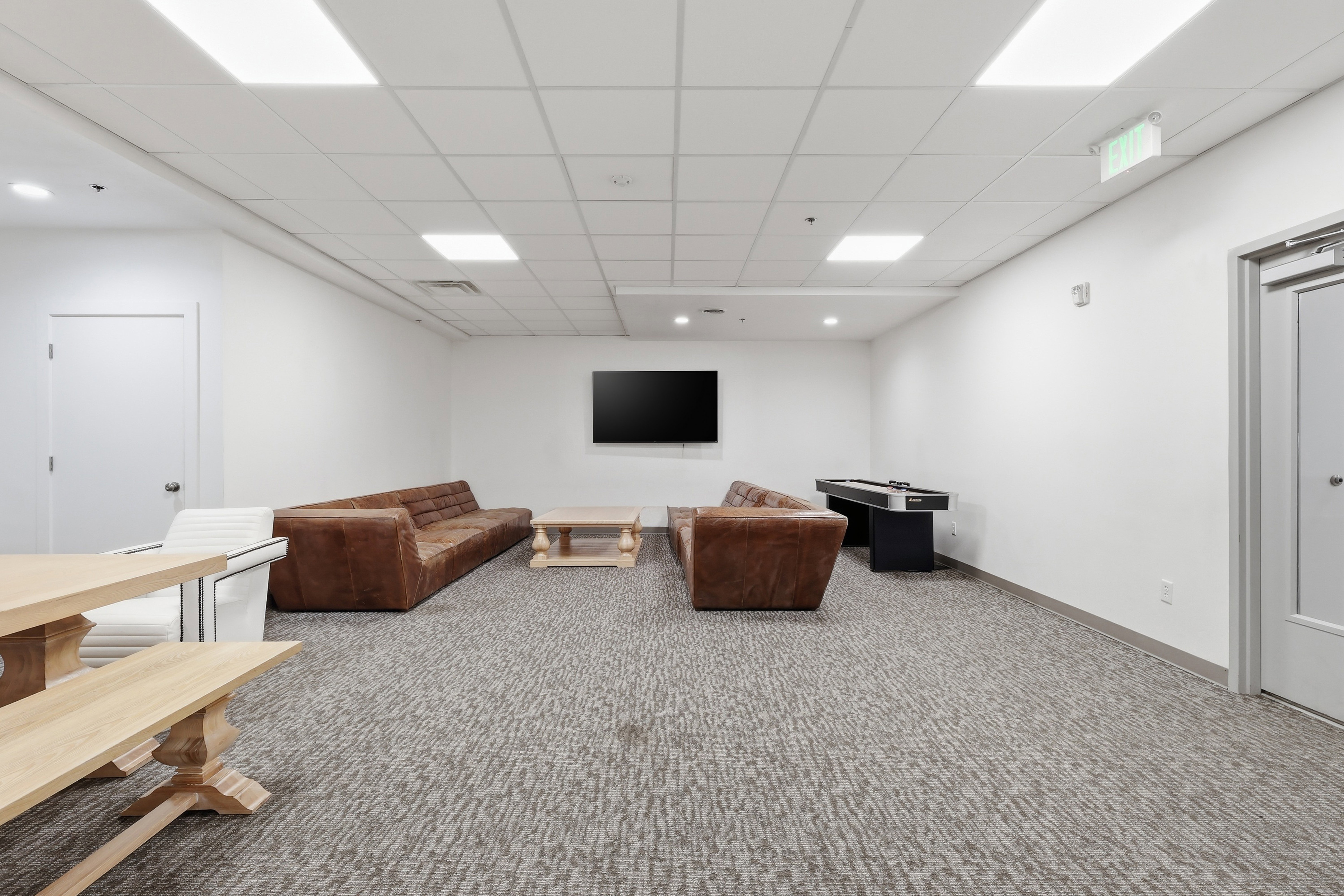 Spacious room featuring neutral carpeting and white walls