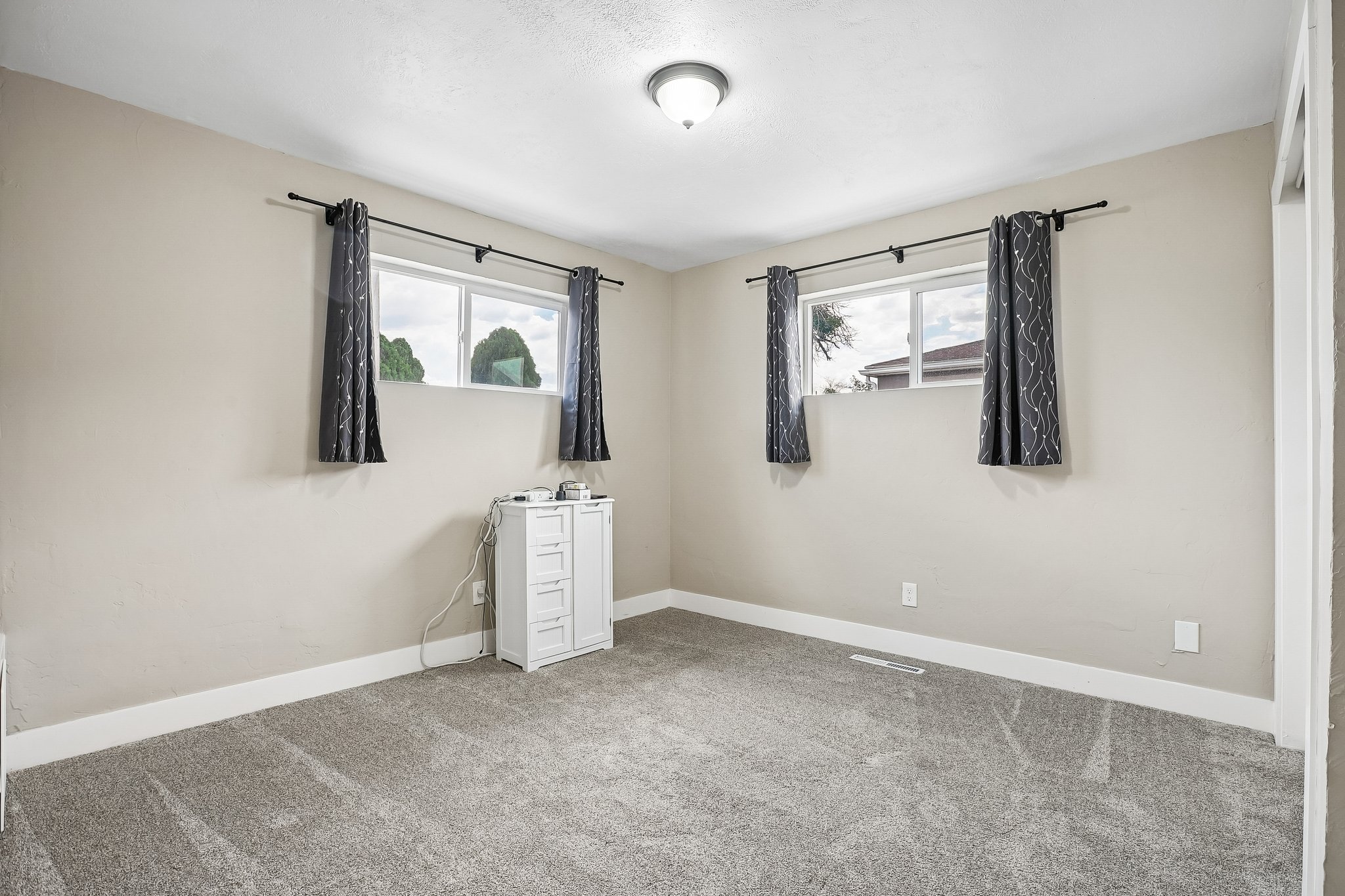 Neutral-toned walls and grey carpet flooring